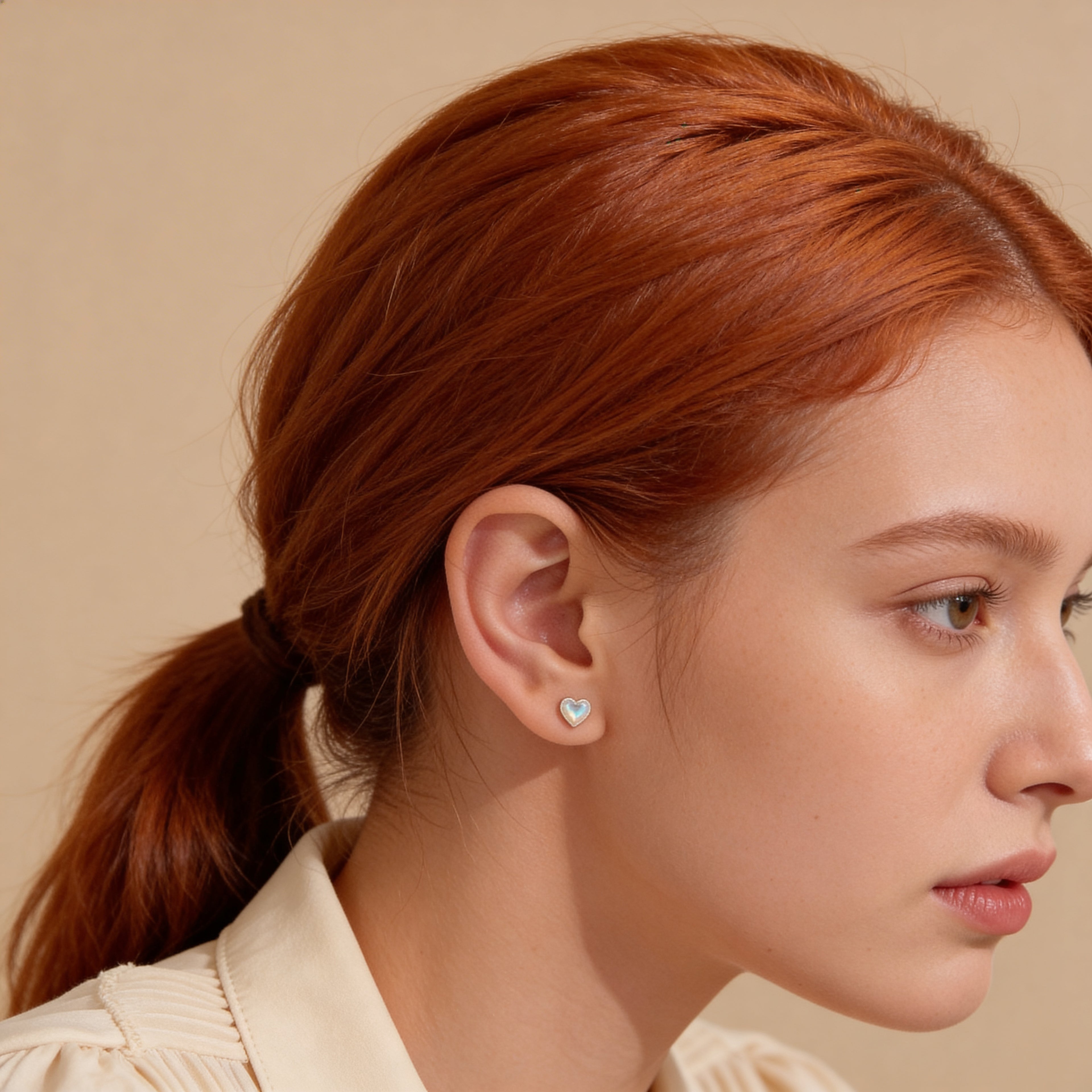 Opalescent heart stud earrings with silver beaded edge detail.