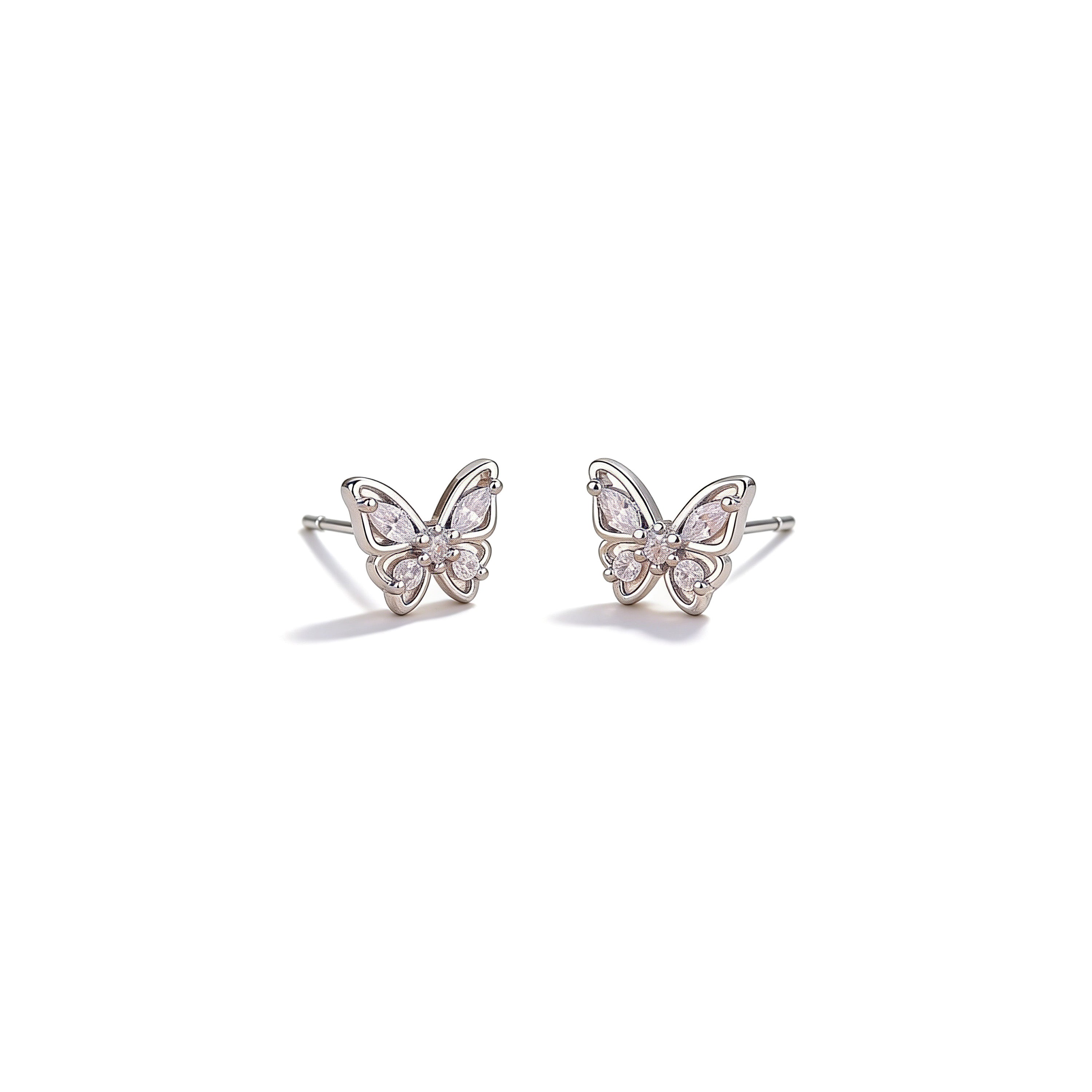 Butterfly-shaped earrings with cz gemstones on a white background