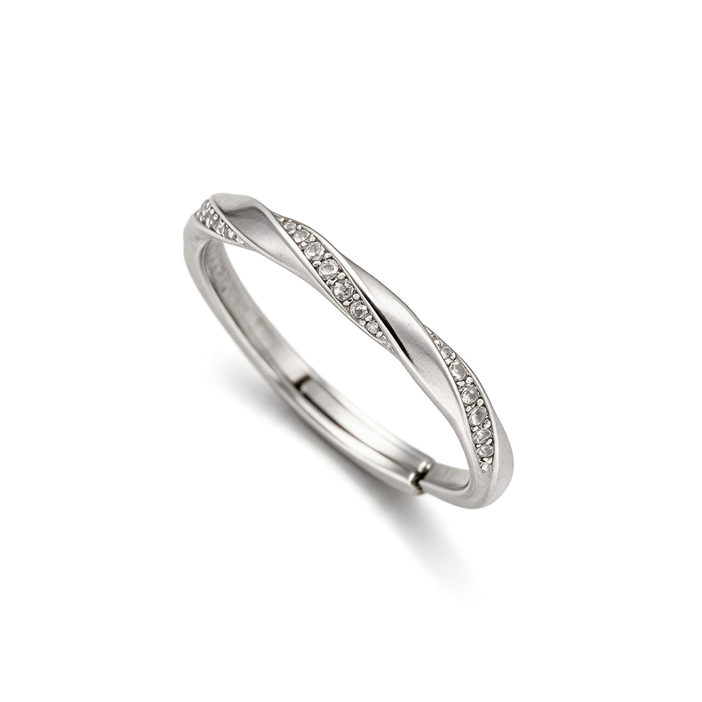 Angled view of adjustable silver plated twist ring with sparkling crystal accents