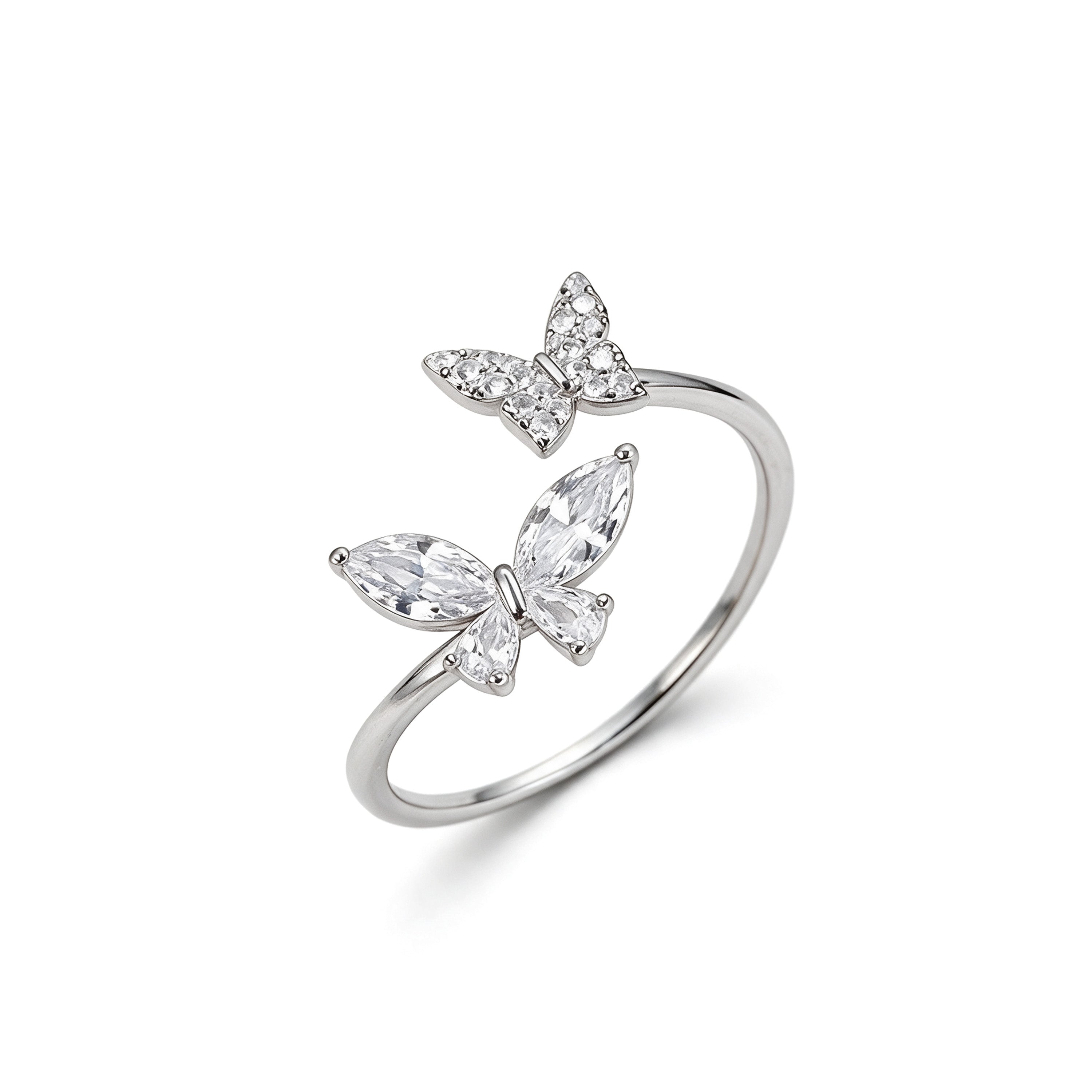 Adjustable silver plated double butterfly ring with sparkling cubic zirconia and crystal stones on white background