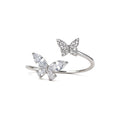 Adjustable silver plated double butterfly ring with sparkling cubic zirconia and crystal stones on white background