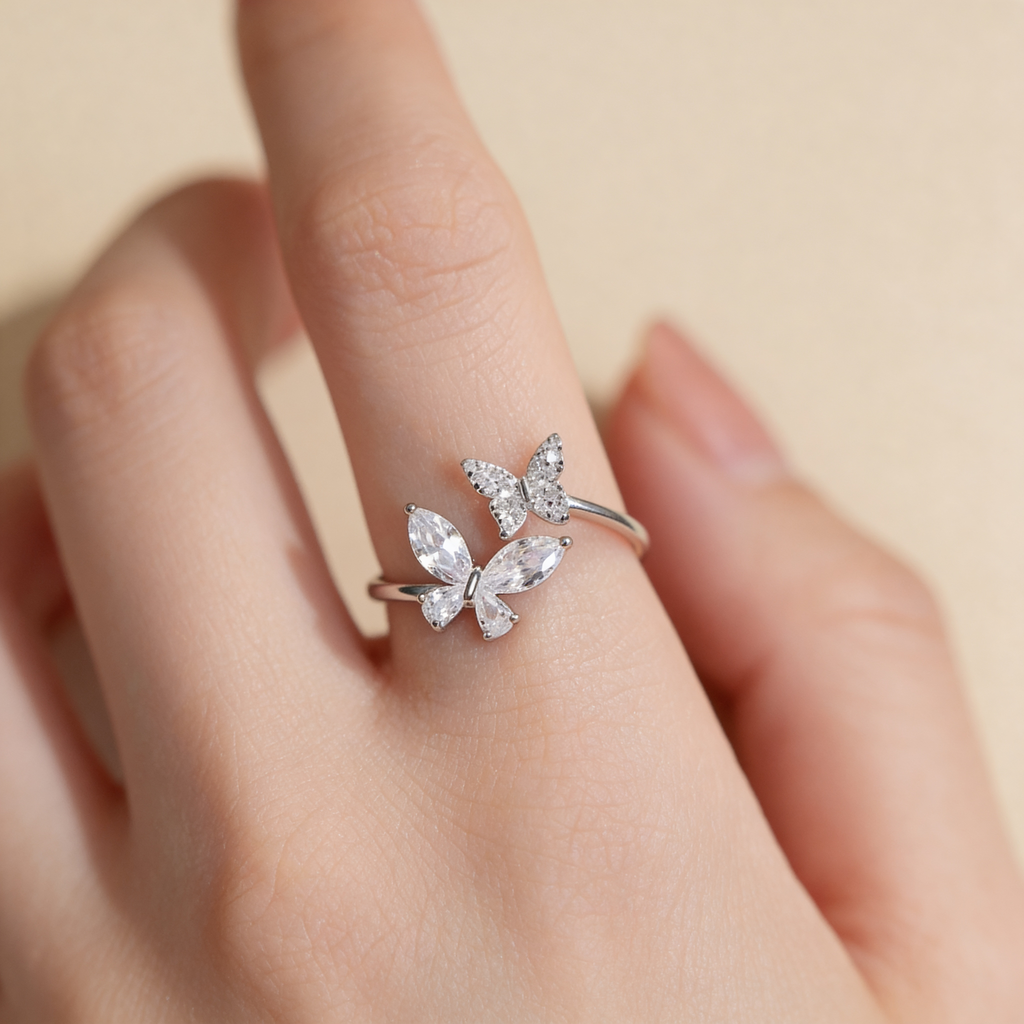 Adjustable silver plated double butterfly ring with sparkling cubic zirconia and crystal stones worn on hand