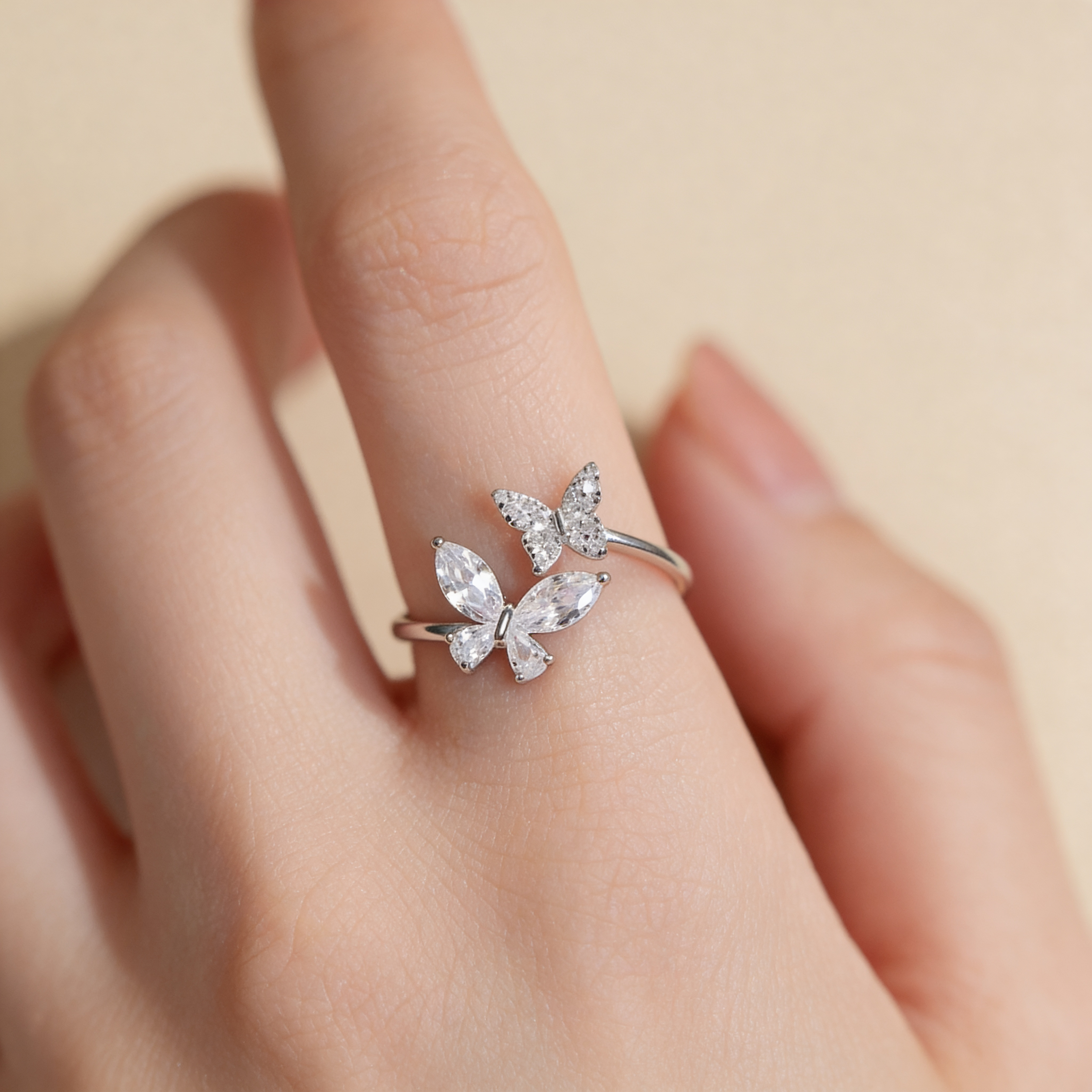 Adjustable silver plated double butterfly ring with sparkling cubic zirconia and crystal stones worn on hand
