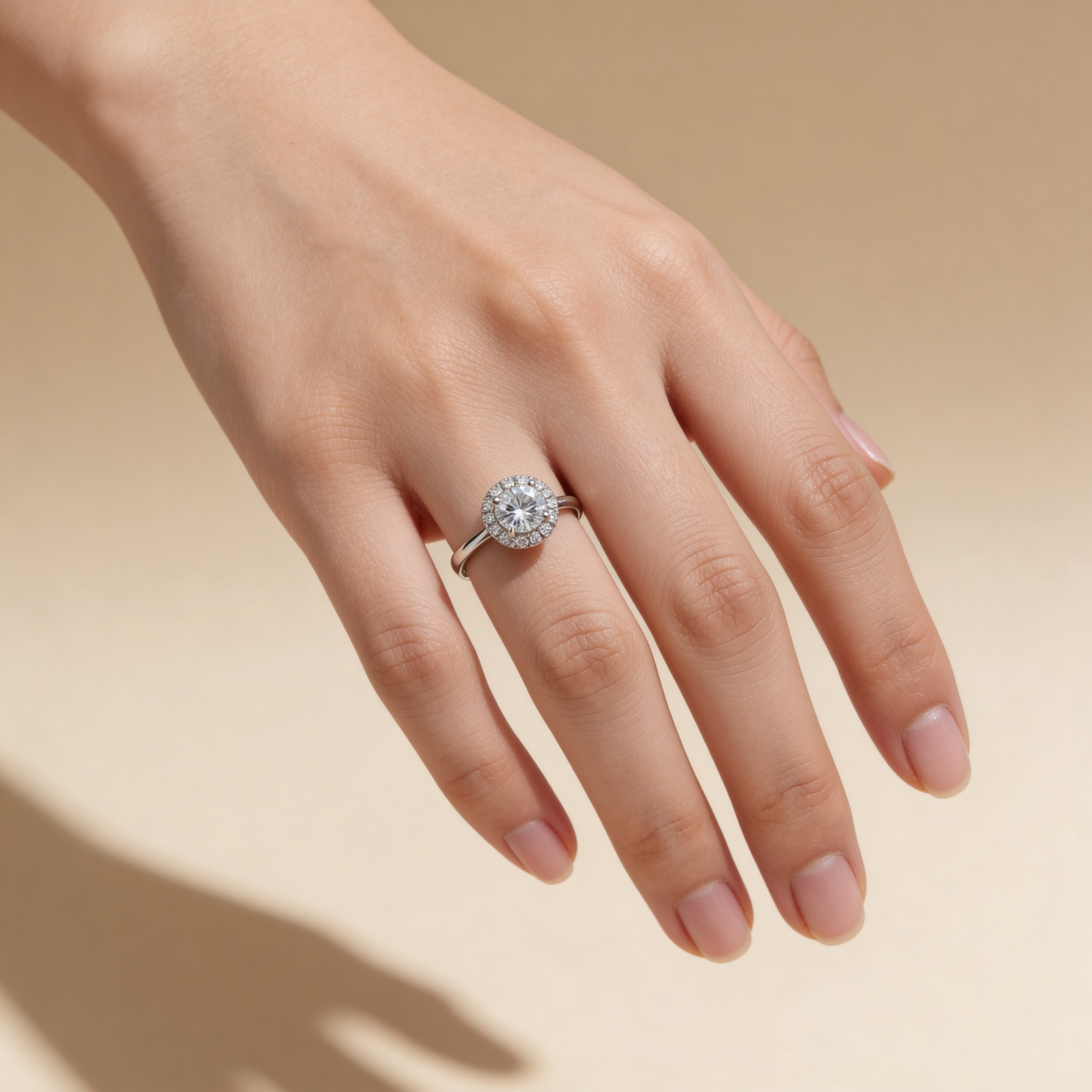 Adjustable silver cubic zirconia halo ring worn on hand, engagement-style jewelry