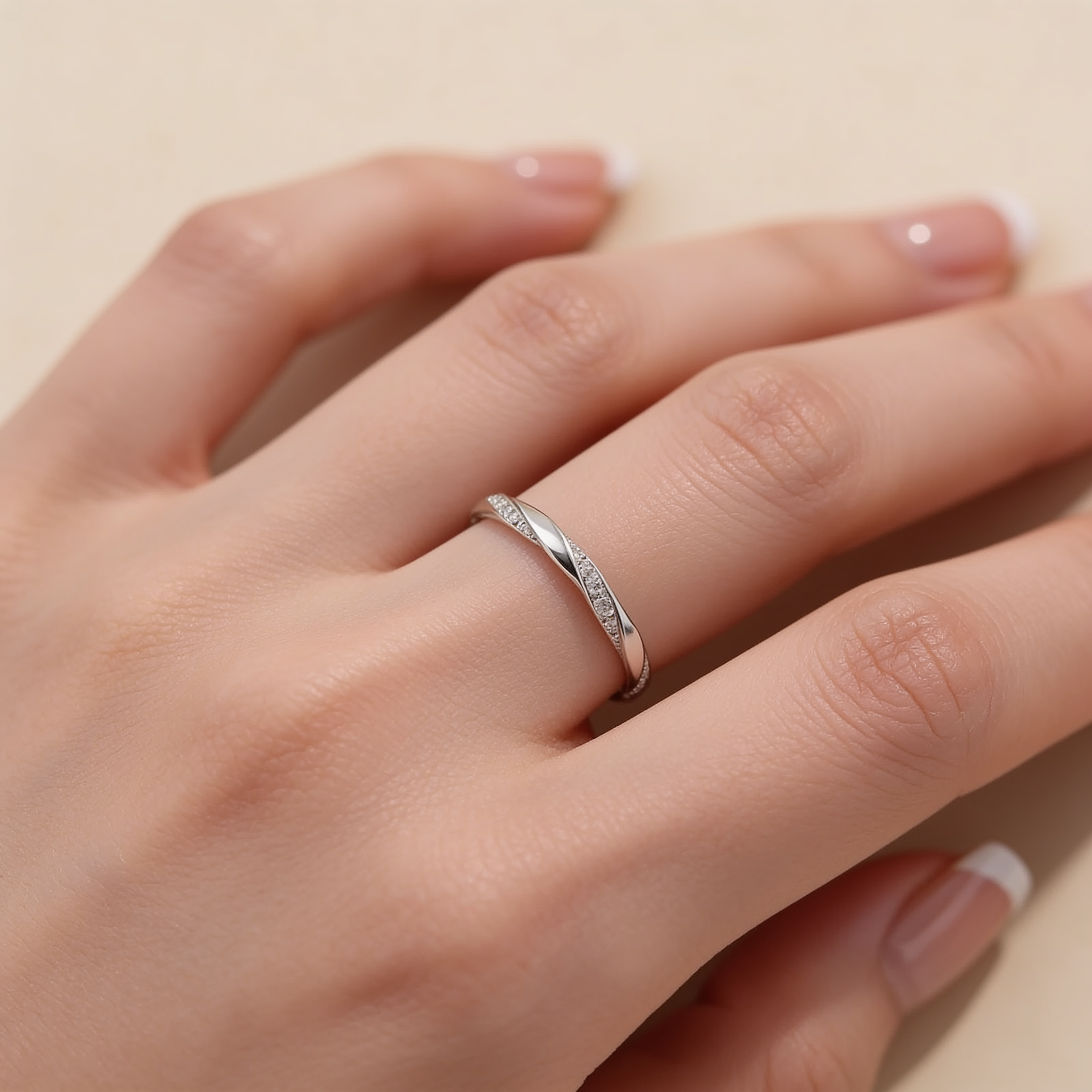 Adjustable silver plated twist ring with sparkling crystal accents worn on hand