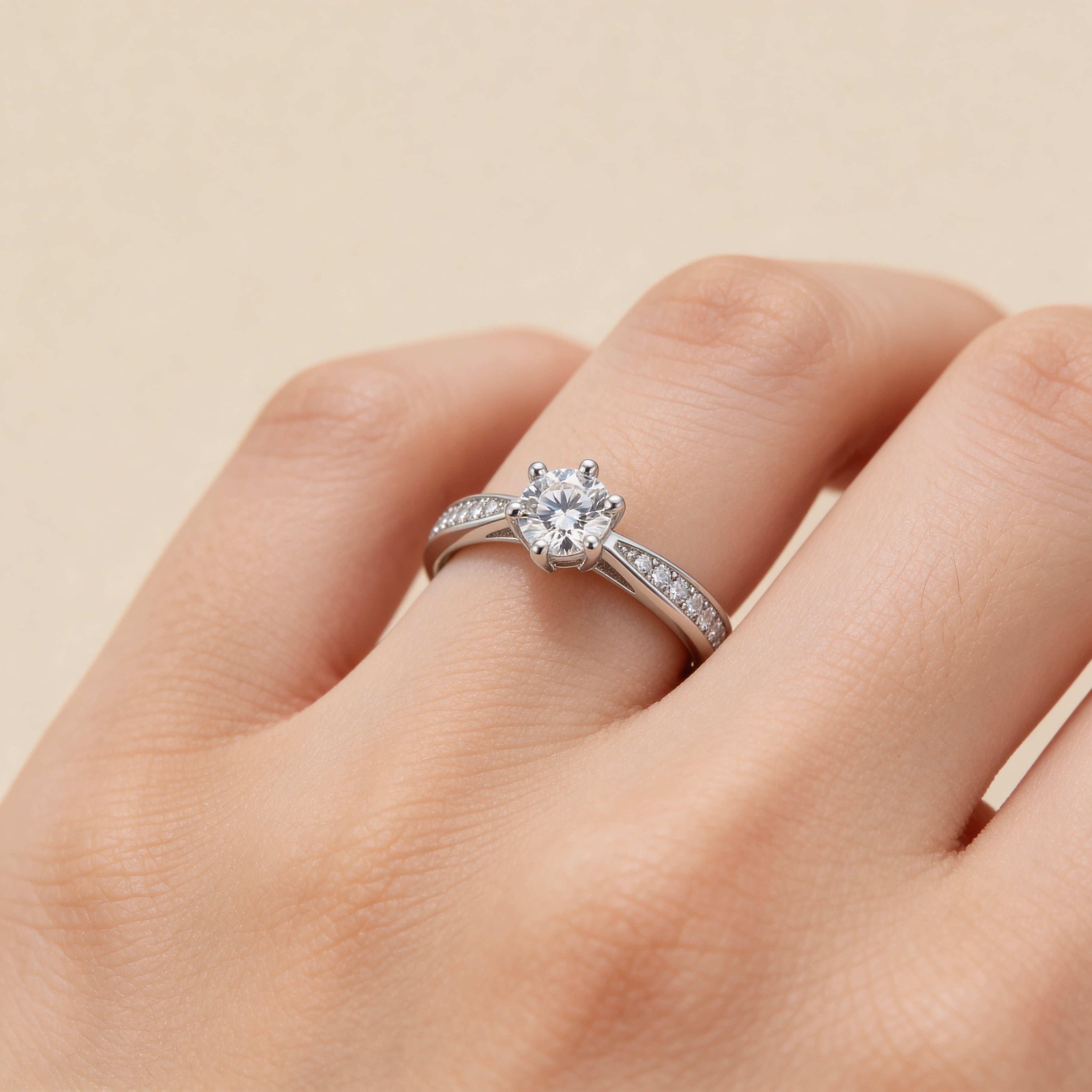 Silver plated solitaire ring with round cubic zirconia center stone and pavé CZ accent band, classic engagement-style promise ring for women with elegant minimalist design.