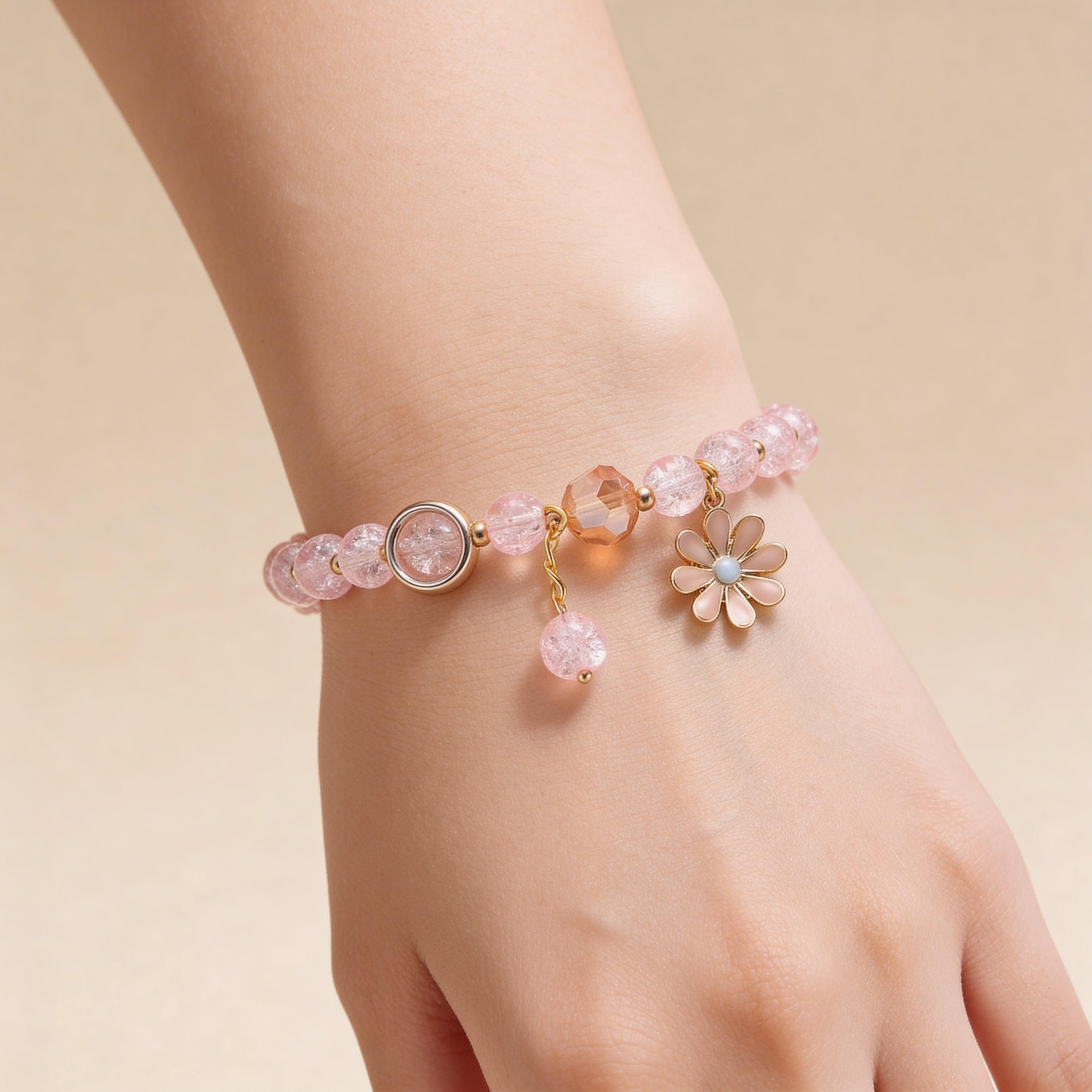 Pink beaded bracelet with daisy charm for children.