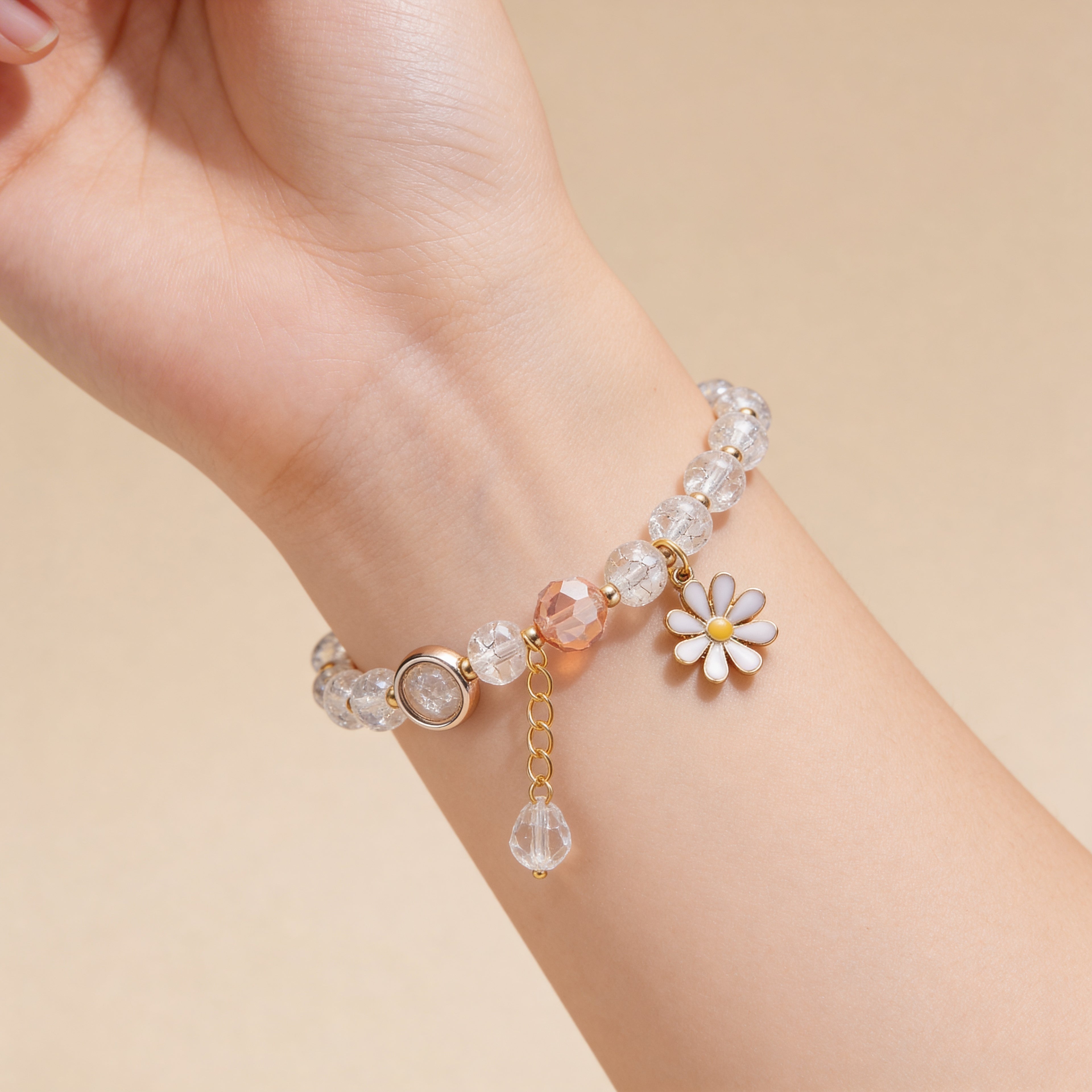 White beaded bracelet with daisy charm for children.