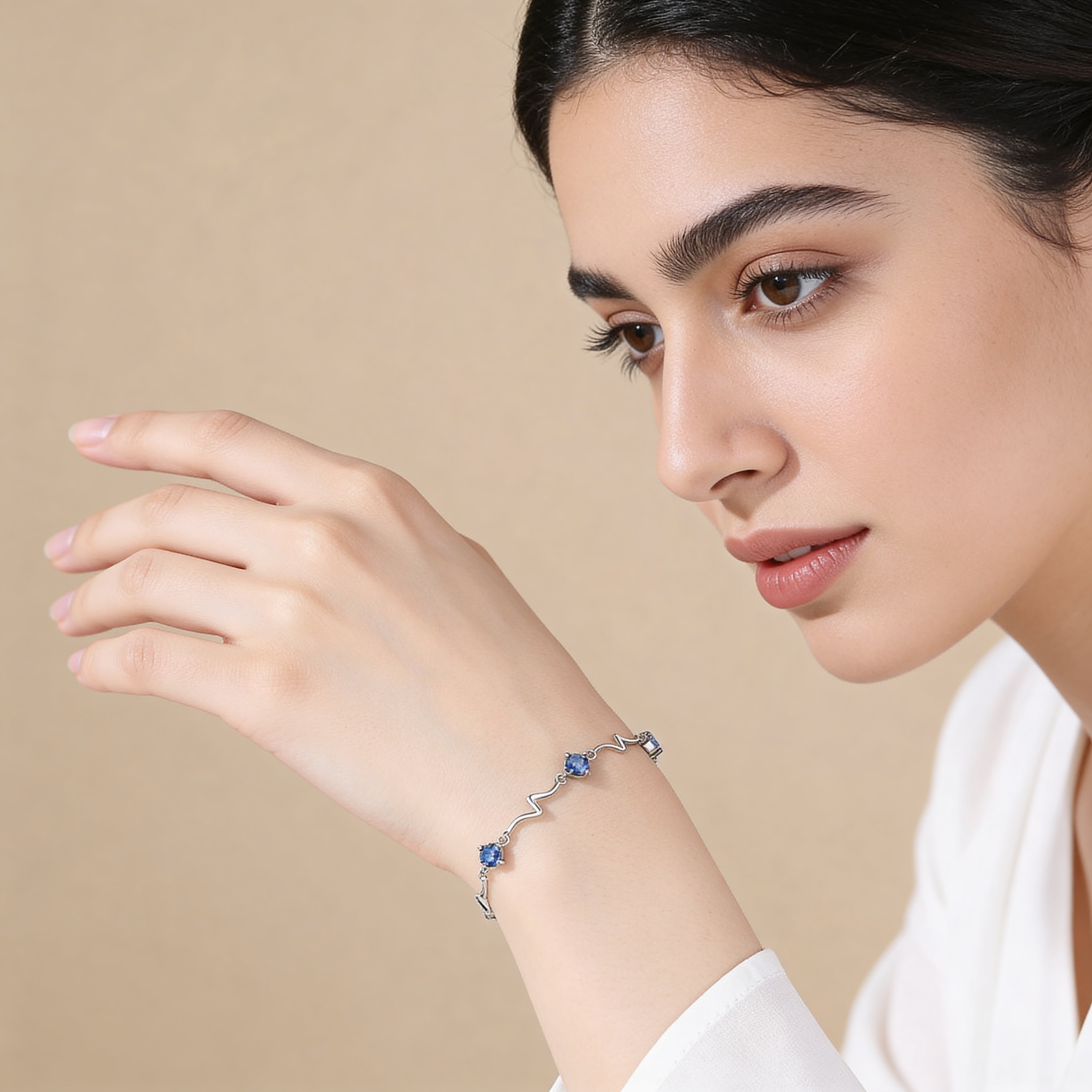 Dainty silver bracelet with sparkling blue crystals.