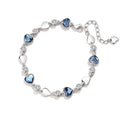 Silver plated blue heart charm bracelet with CZ crystals.