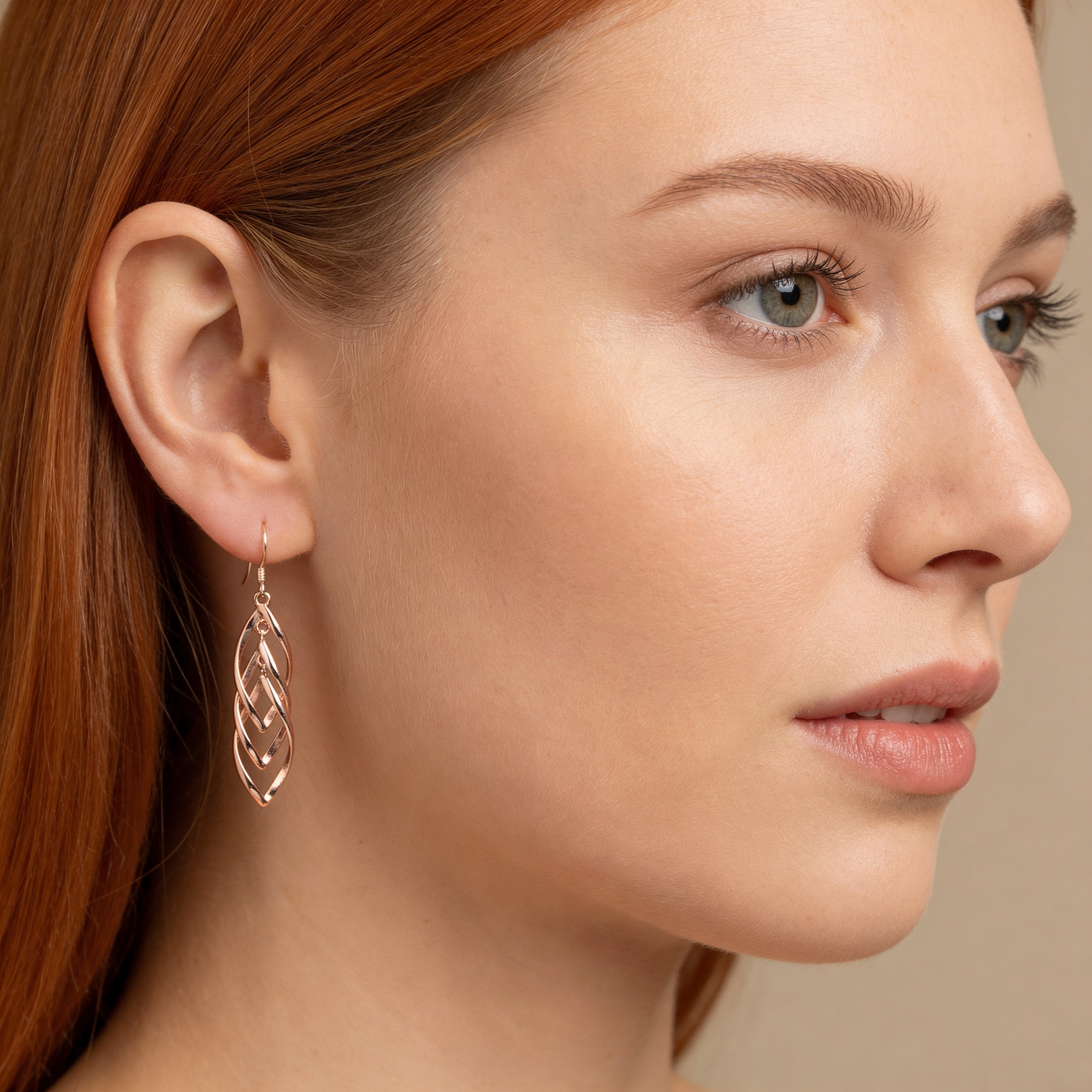 Layered rose gold leaf drop earrings with hook fastening.