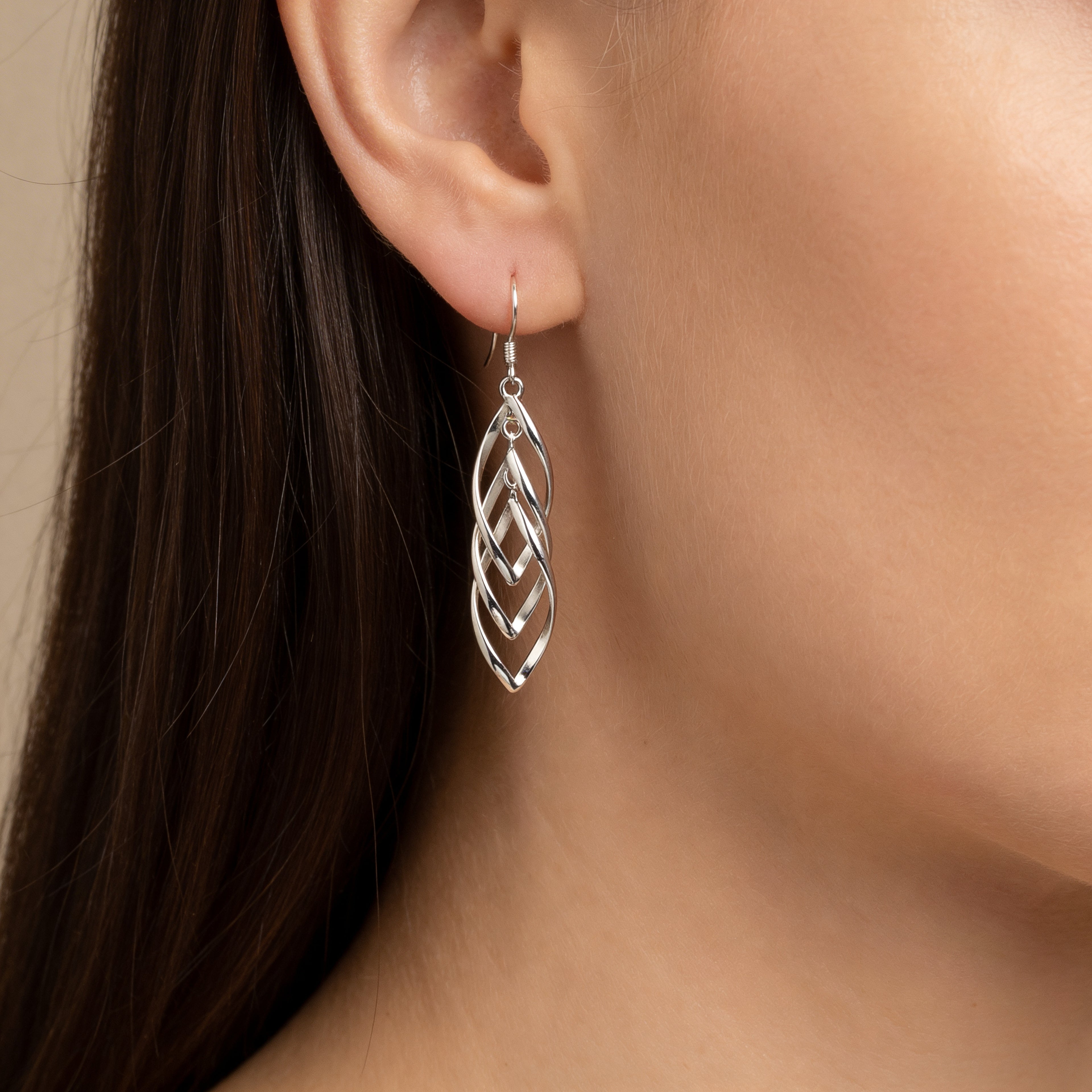 Layered silver leaf drop earrings with hook fastening.