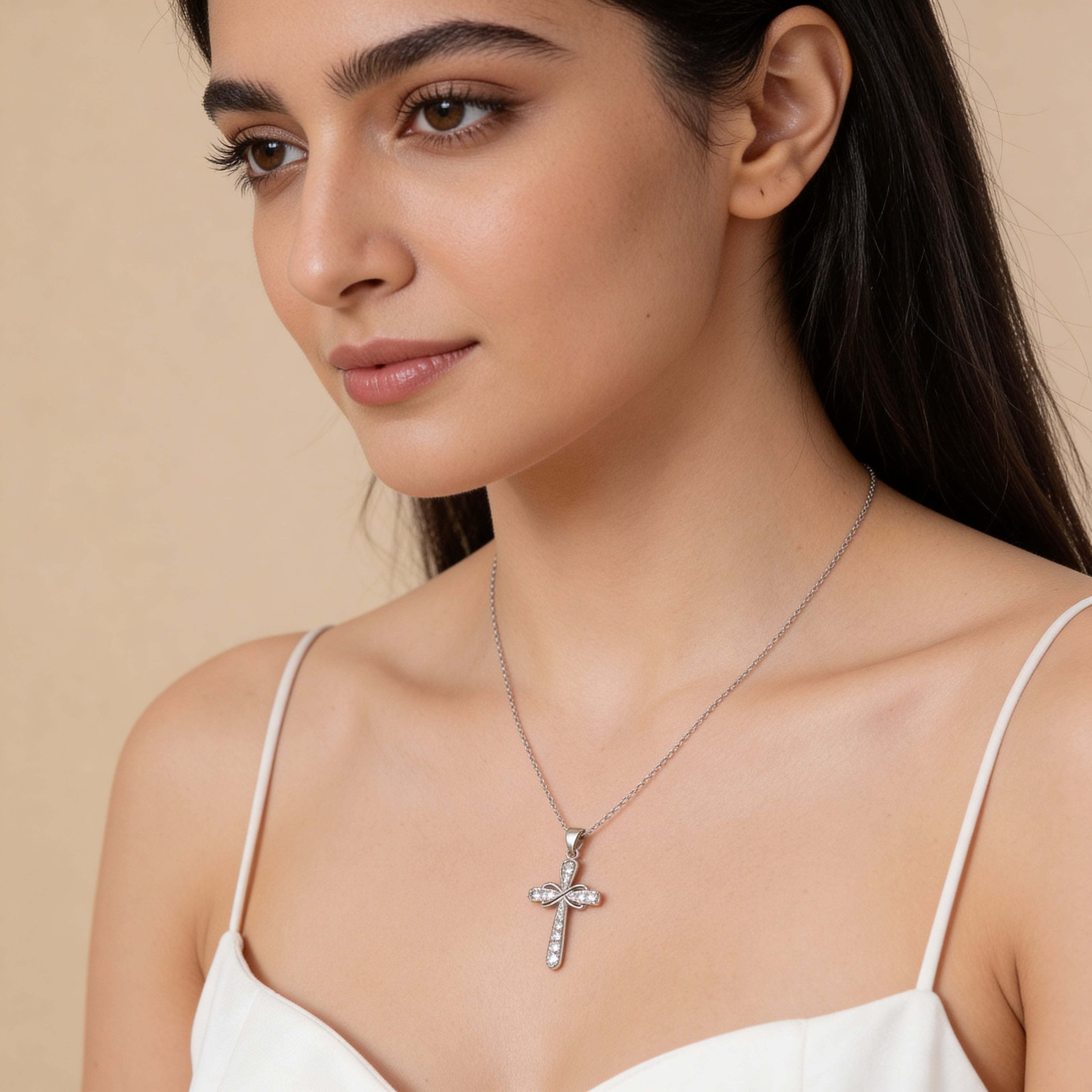 Elegant crystal cross pendant necklace close-up.