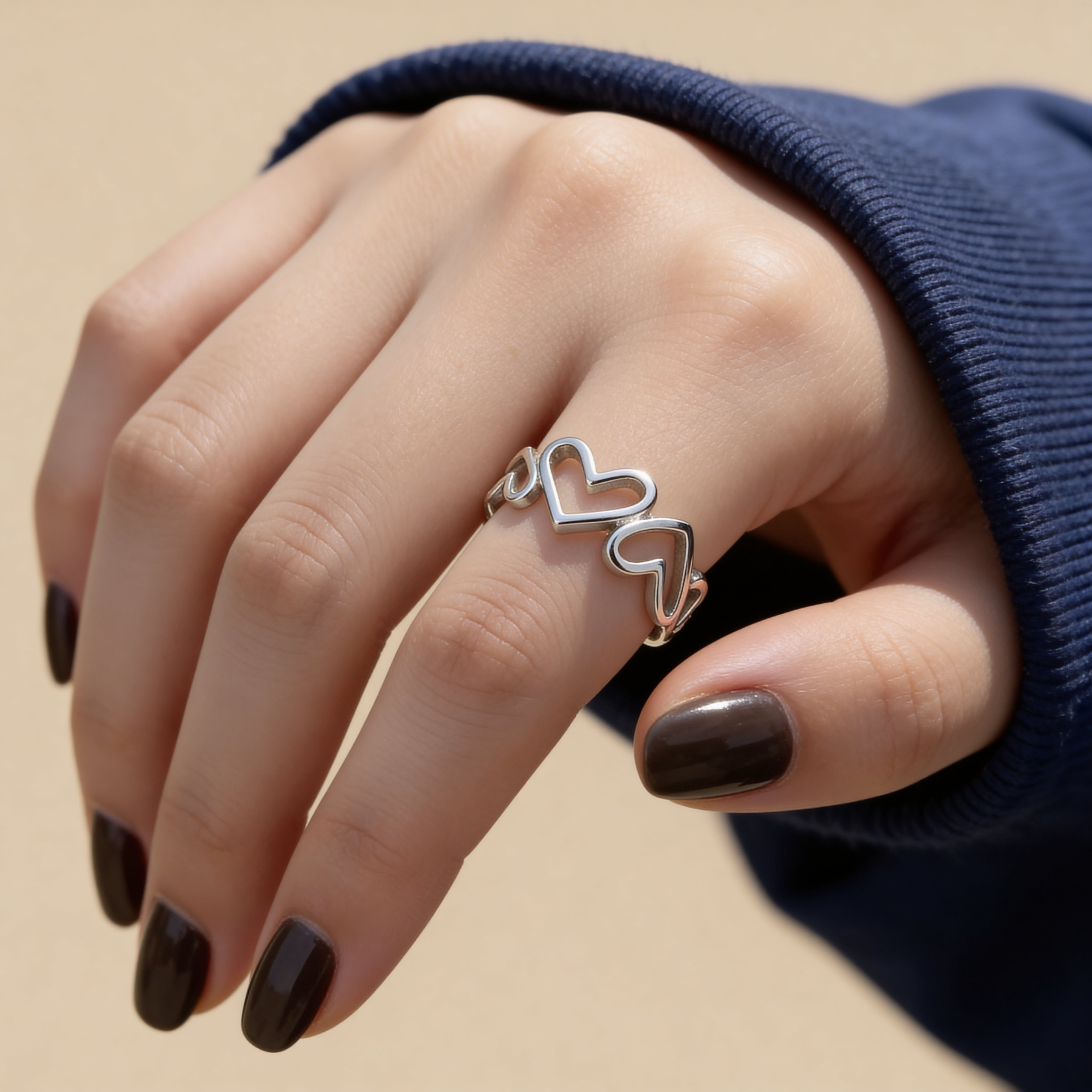 Connected open heart silver plated ring with adjustable band design.