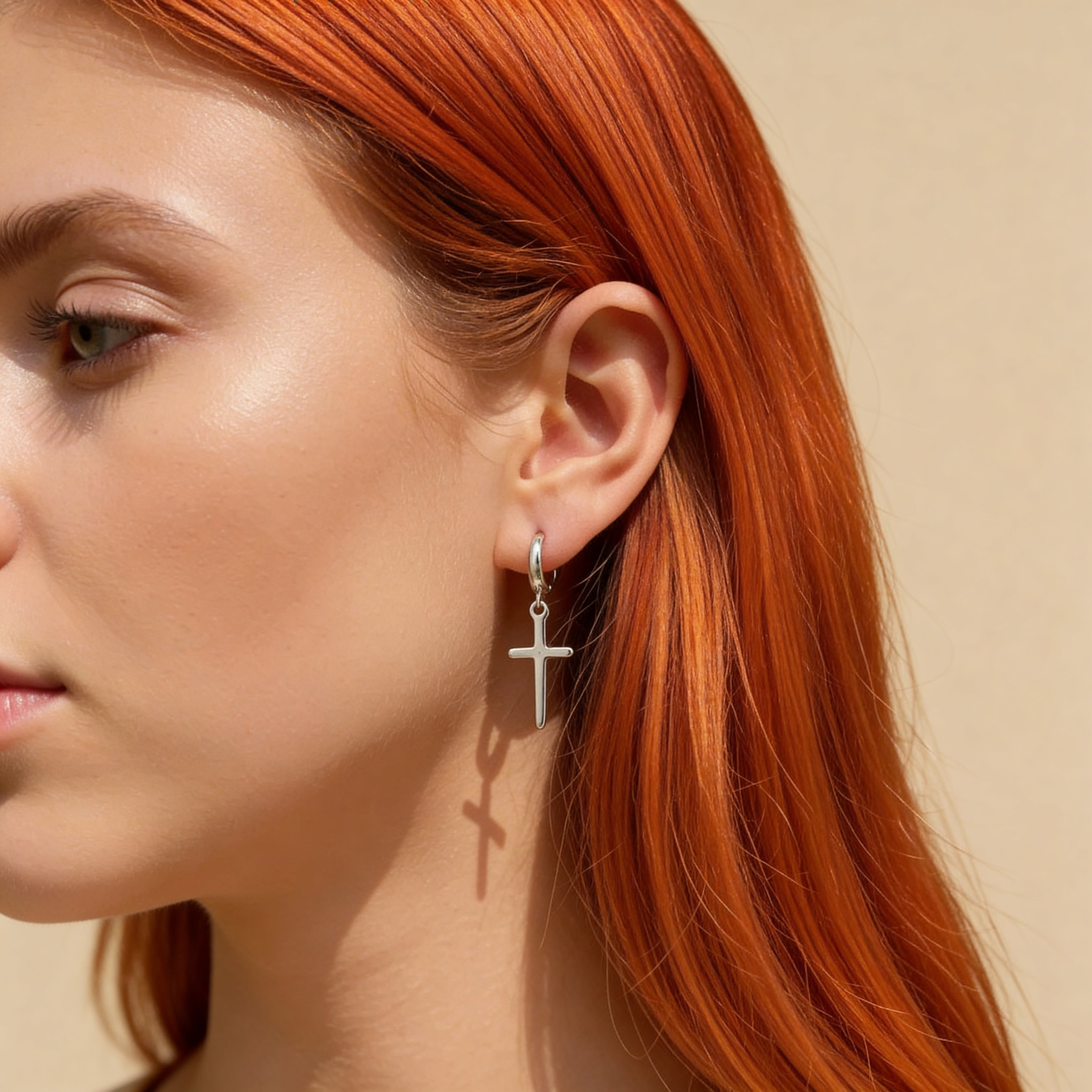 Small silver cross huggie hoop earrings polished finish.