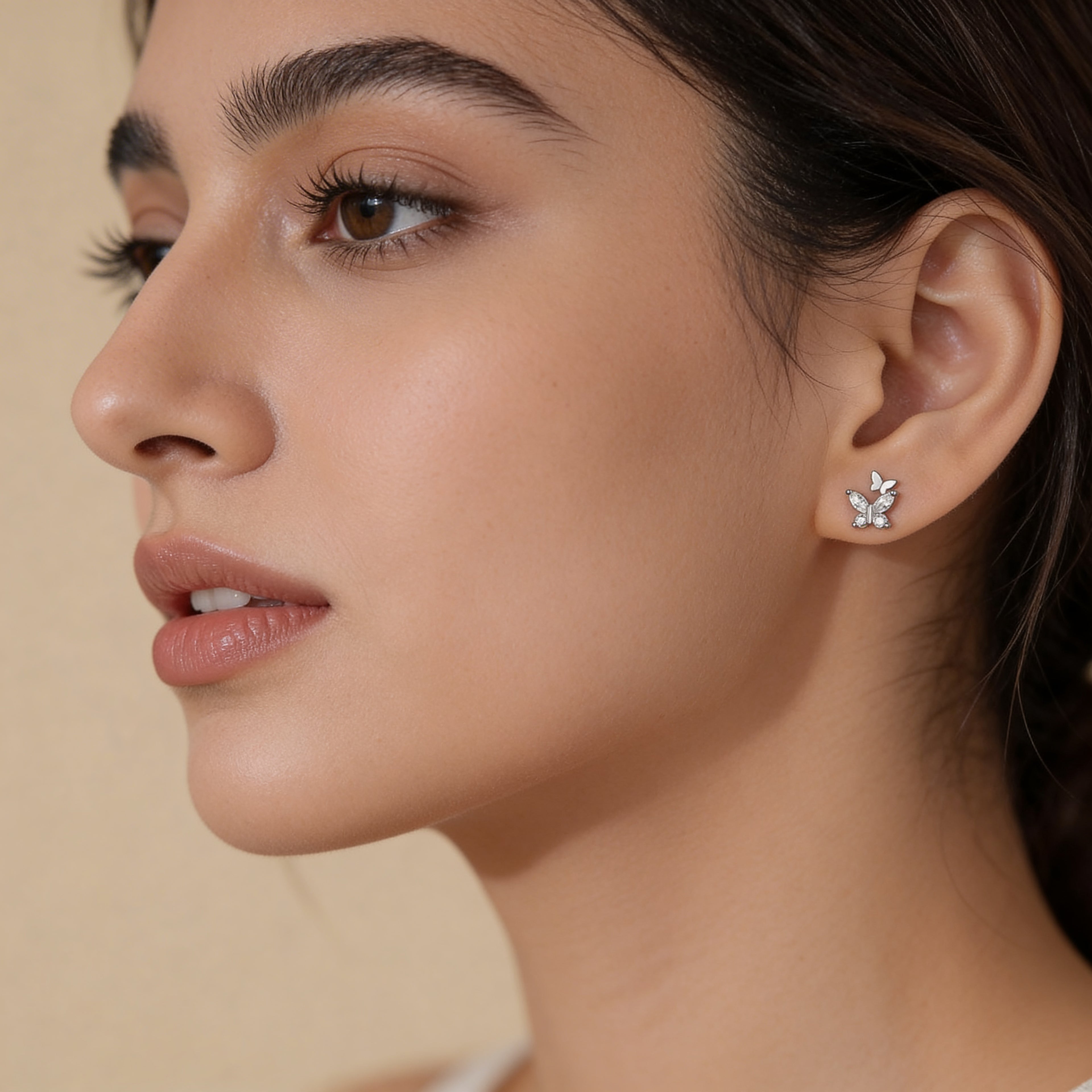 Minimal silver butterfly stud earrings with crystals worn on ear subtle everyday jewellery