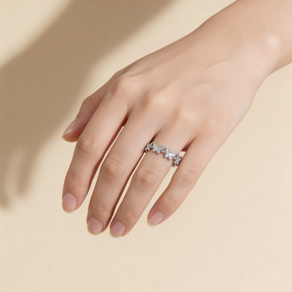 Cubic zirconia butterfly ring in polished silver plated finish.