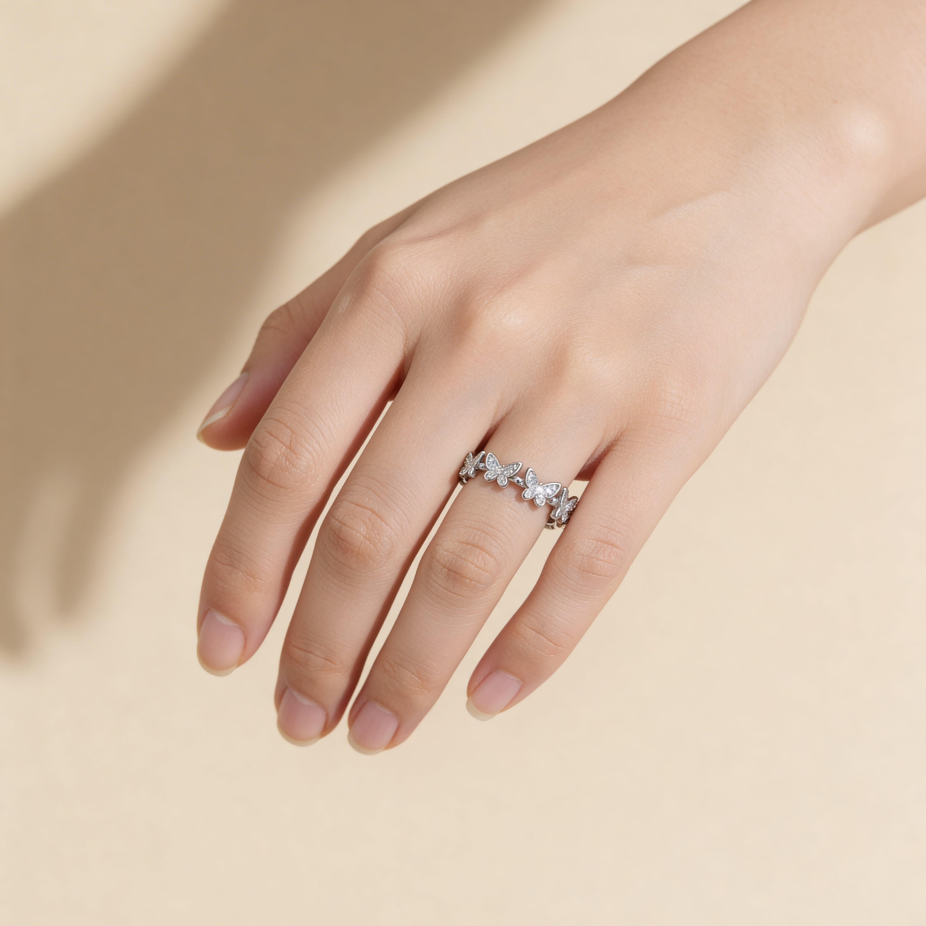 Cubic zirconia butterfly ring in polished silver plated finish.