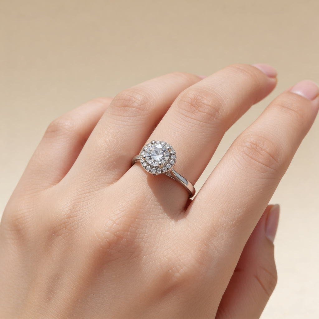 Round CZ halo ring in polished silver plated finish with pavé detailing.