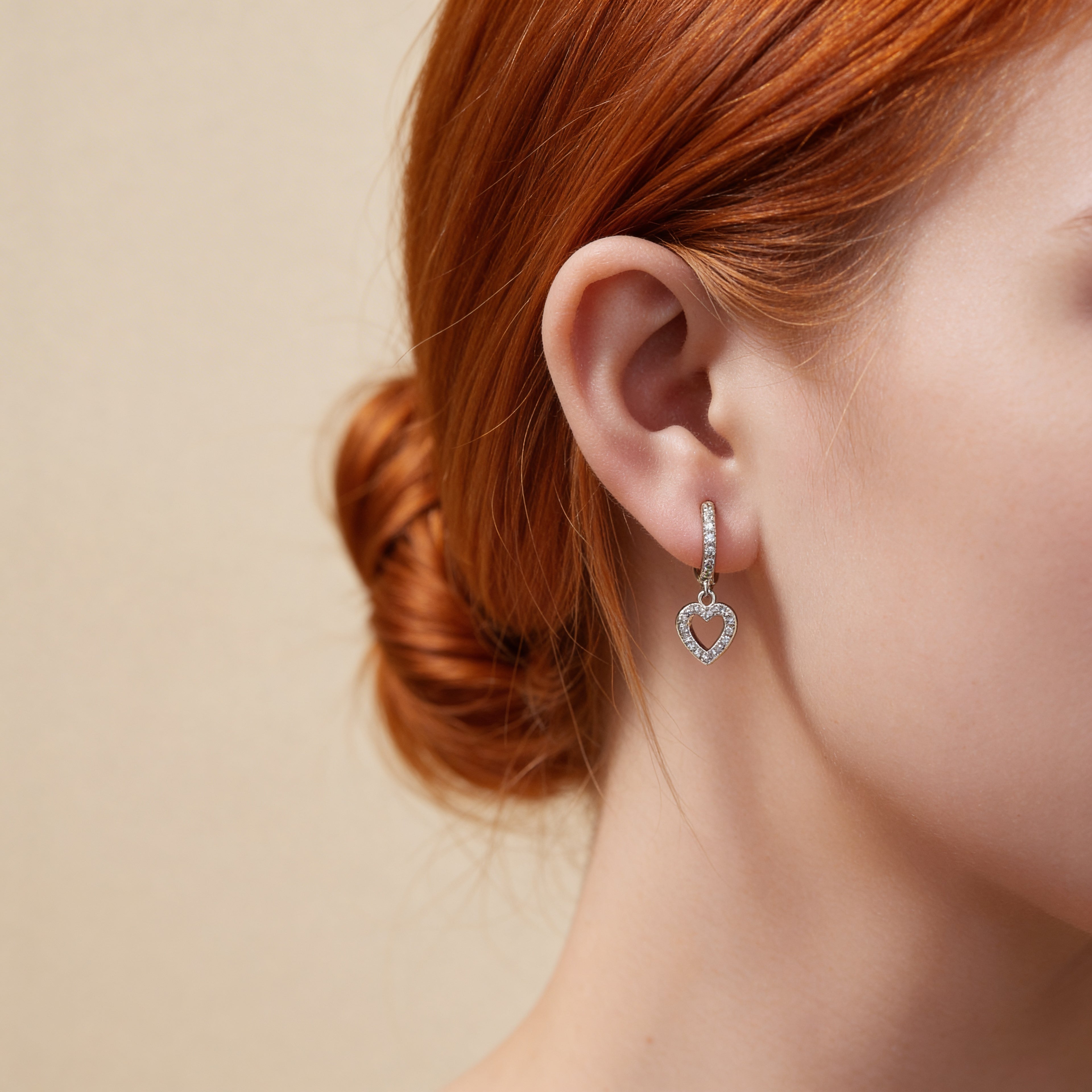 CZ heart charm huggie hoop earrings in silver.