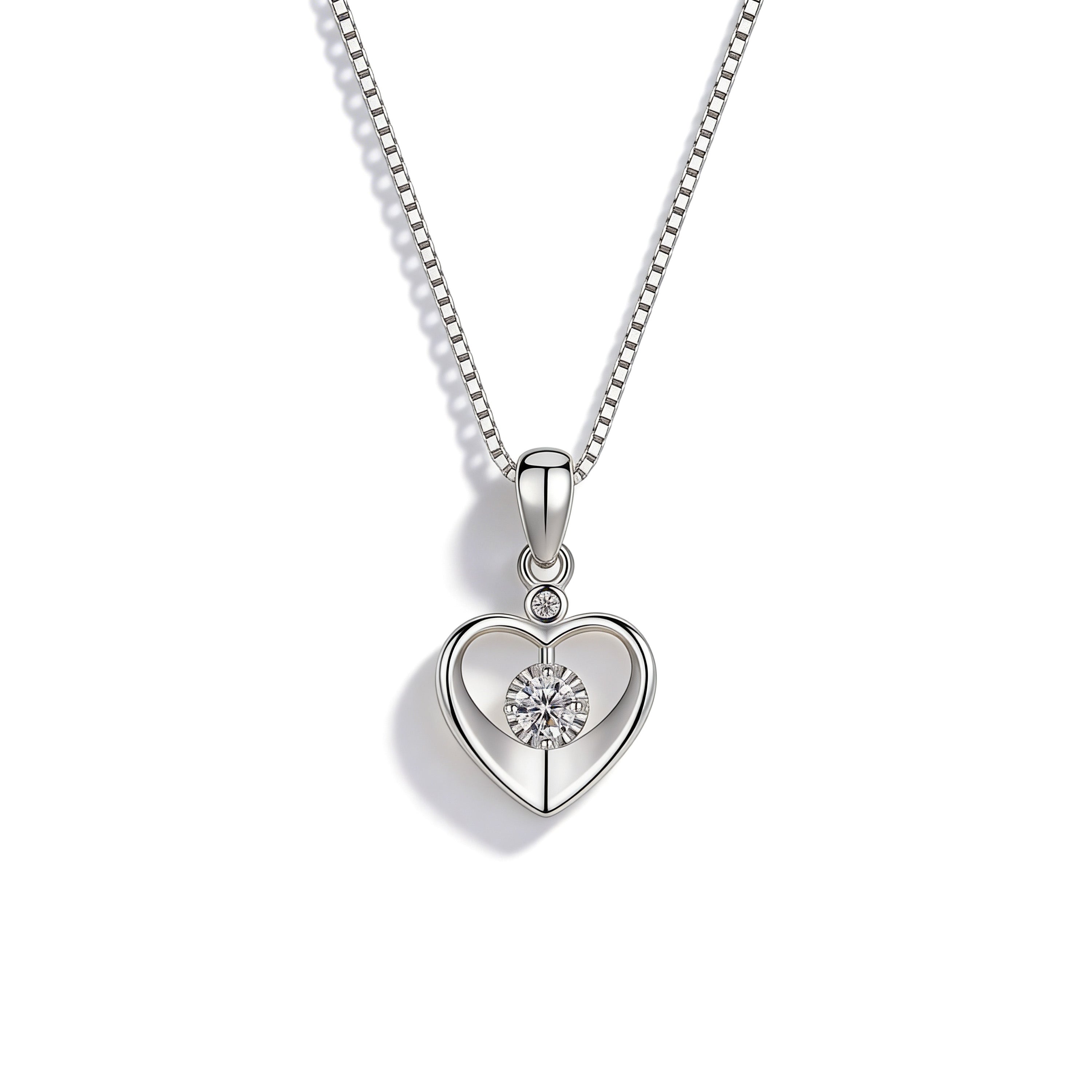 Silver plated heart pendant necklace with cubic zirconia center stone.
