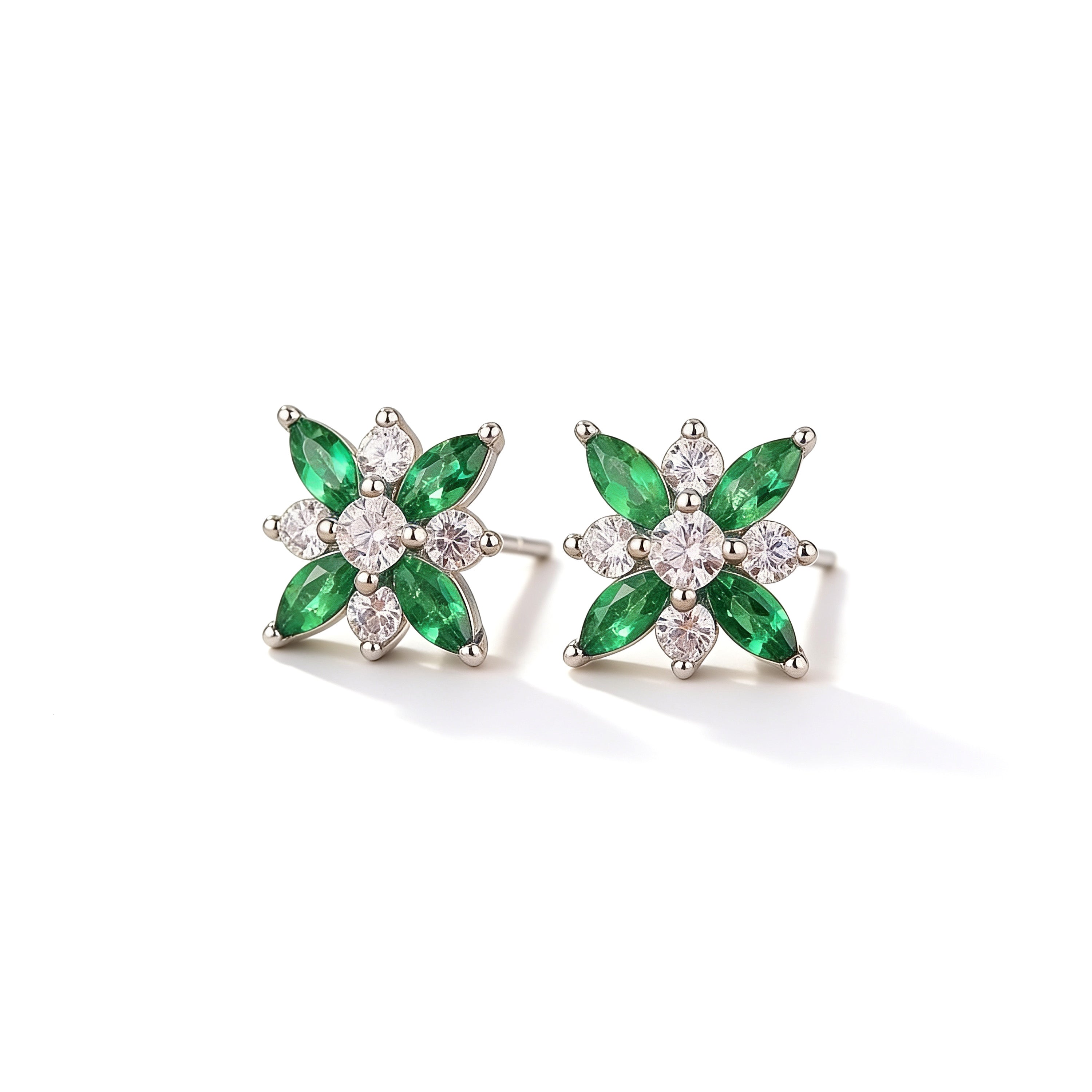Front view of silver plated flower stud earrings with green crystal petals and sparkling white cubic zirconia stones