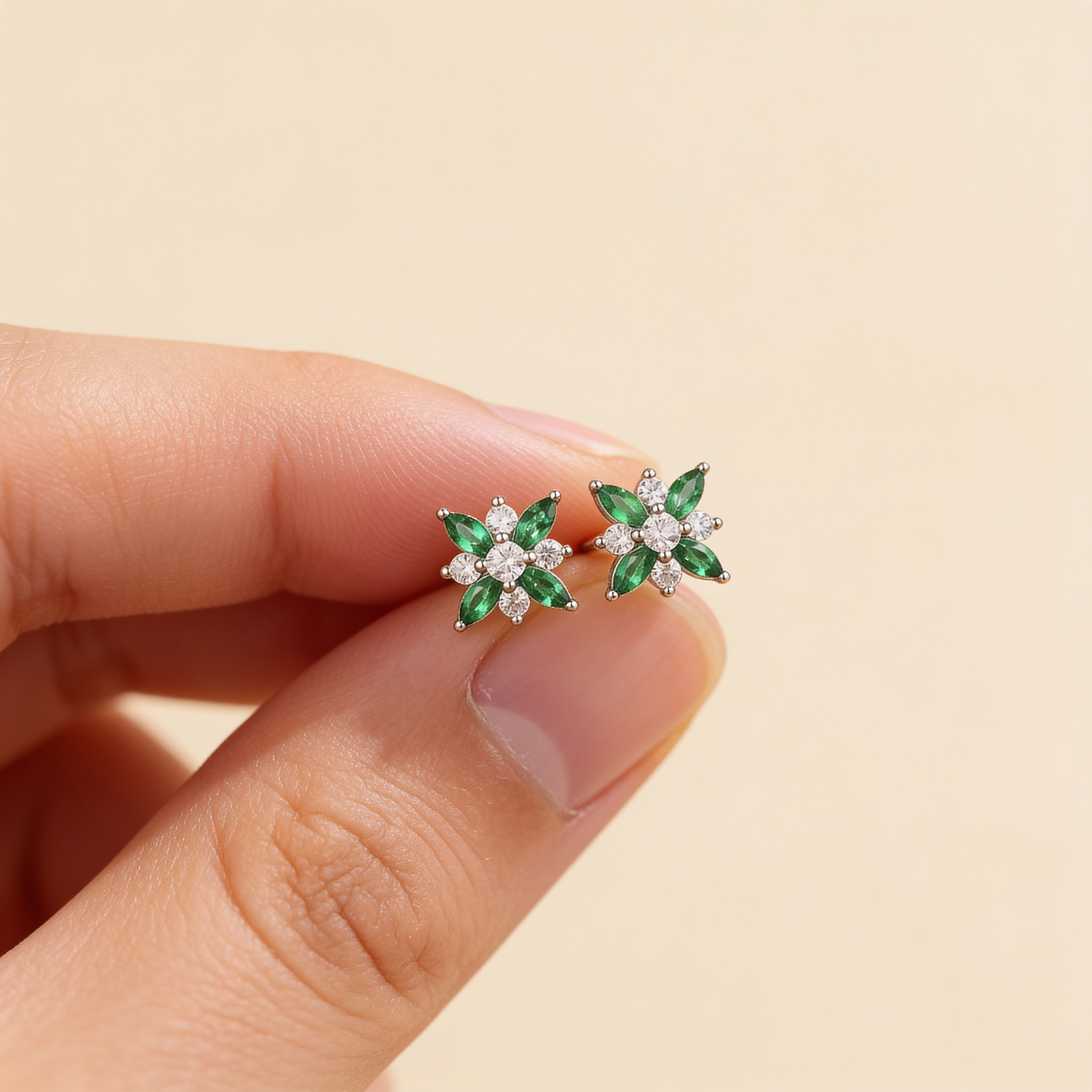 Silver plated green and white crystal flower stud earrings held between fingers to show their 1.1cm size