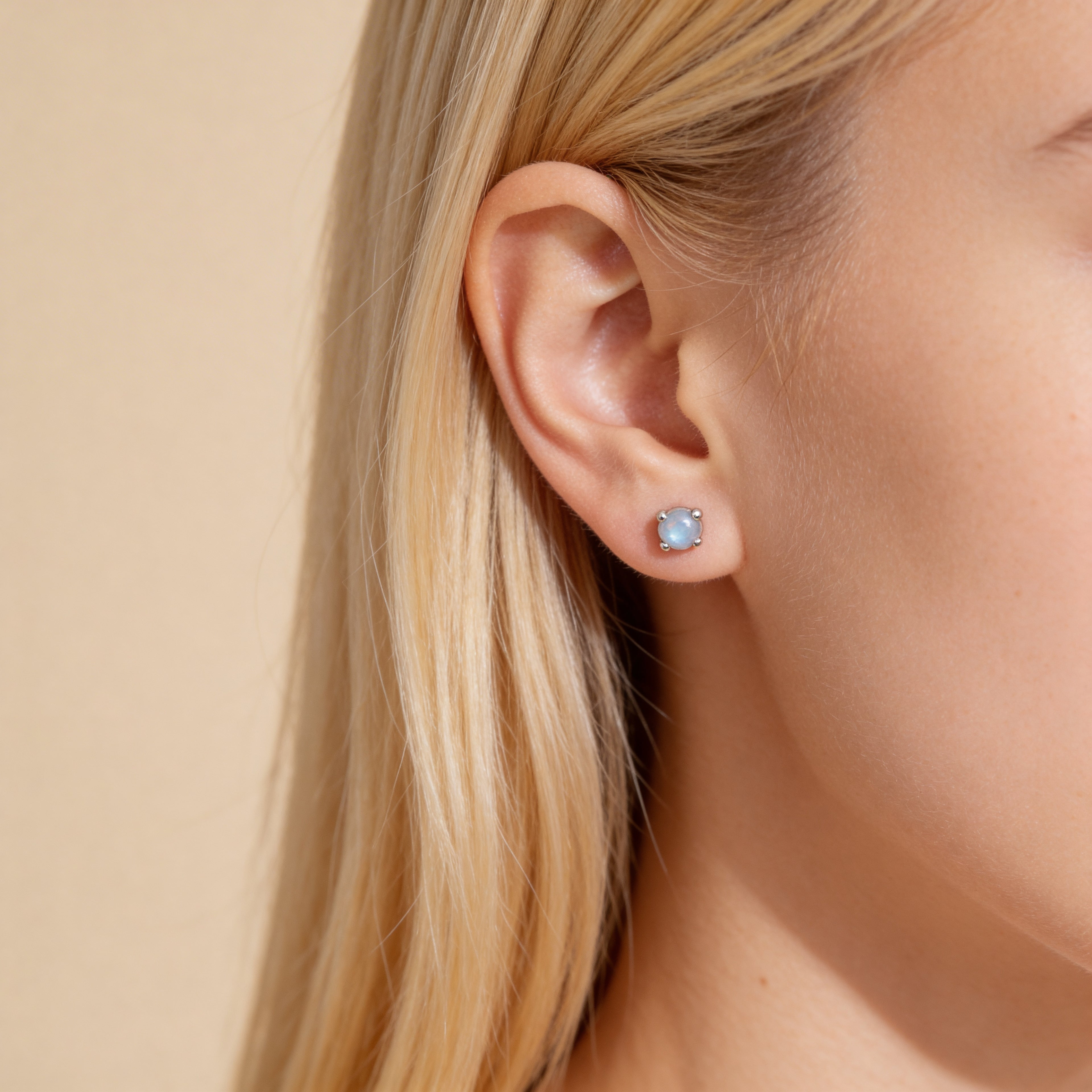 Dainty silver iridescent bead stud earrings with shimmer finish.