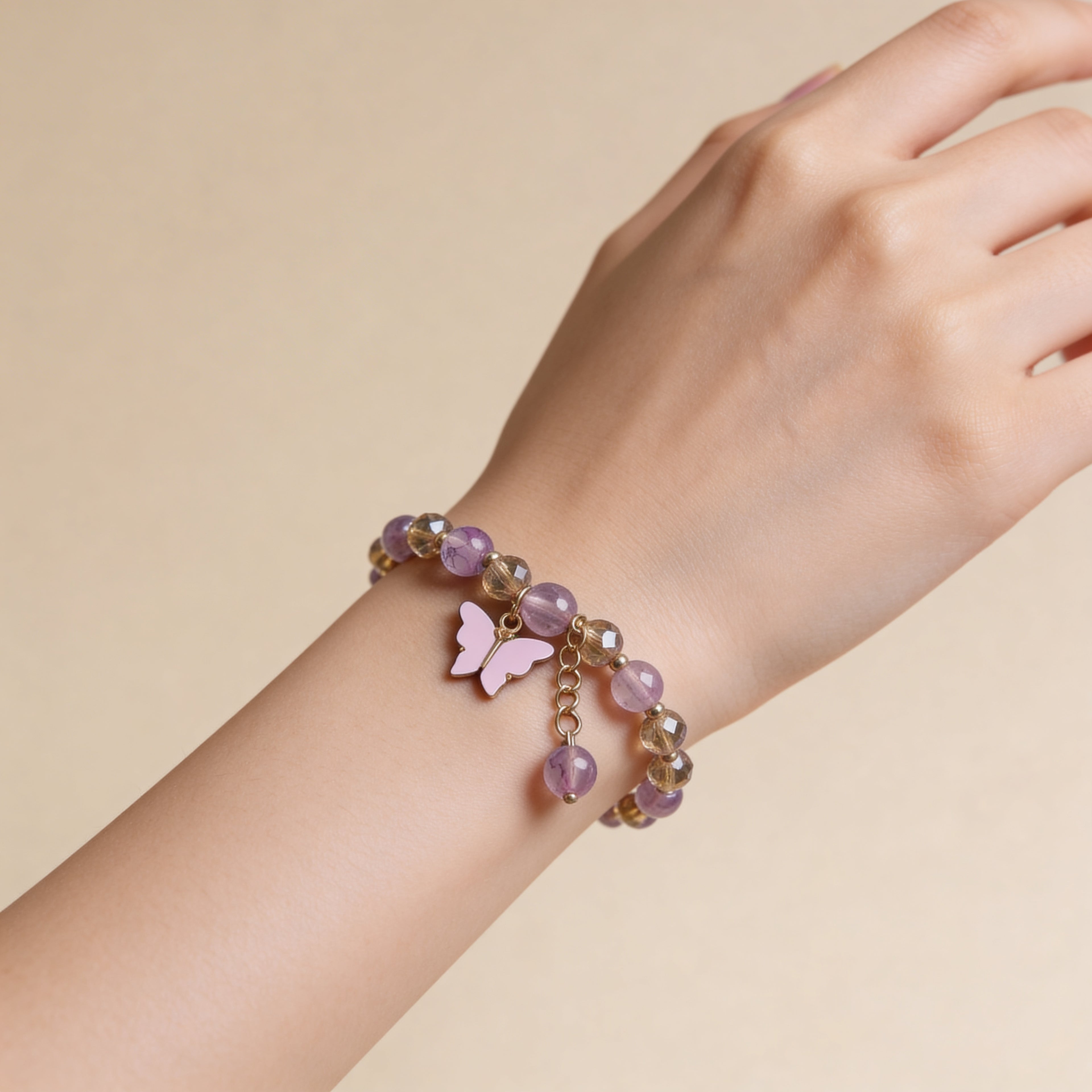 Cute kids bracelet with pink beads and butterfly charm.