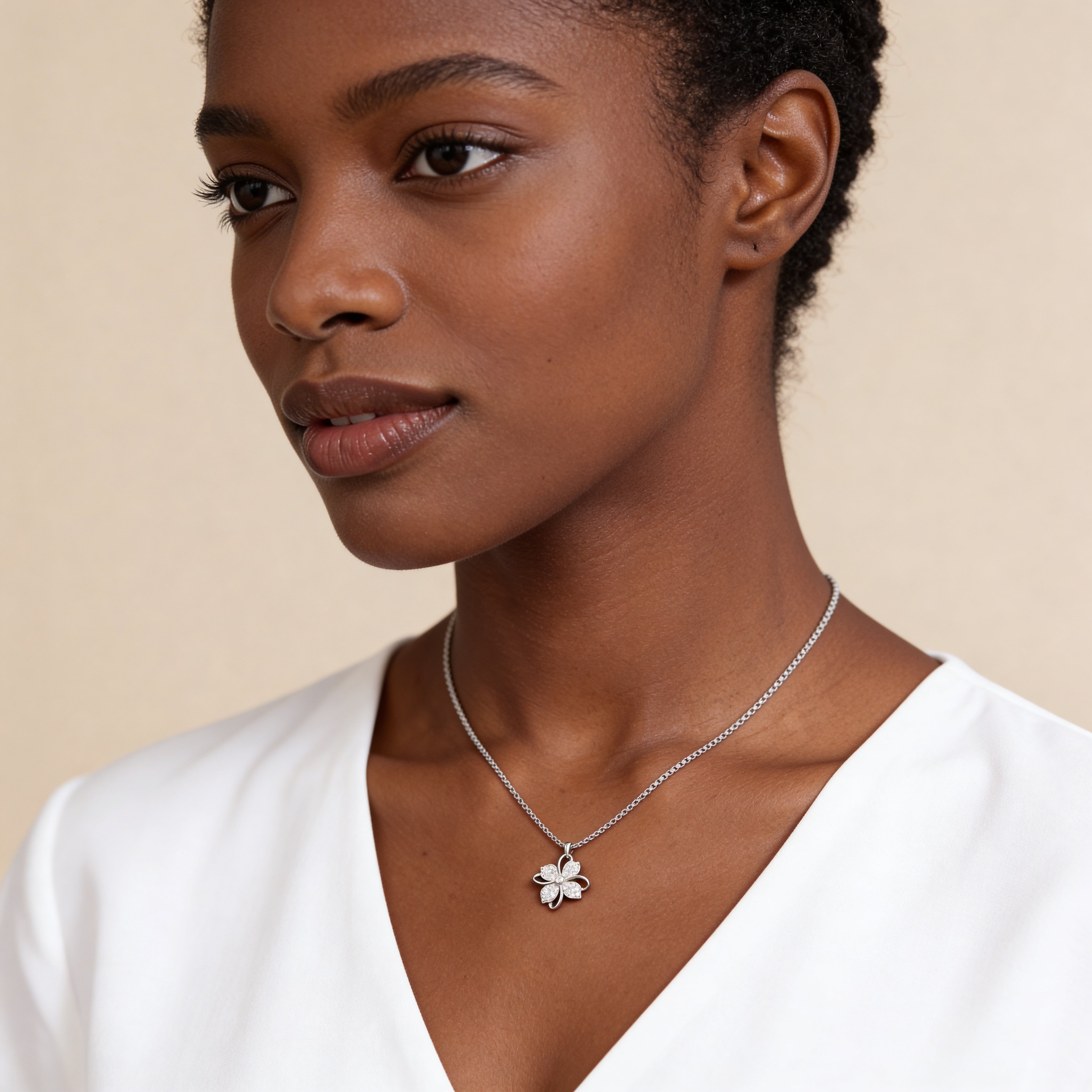 Crystal clover necklace worn by model.