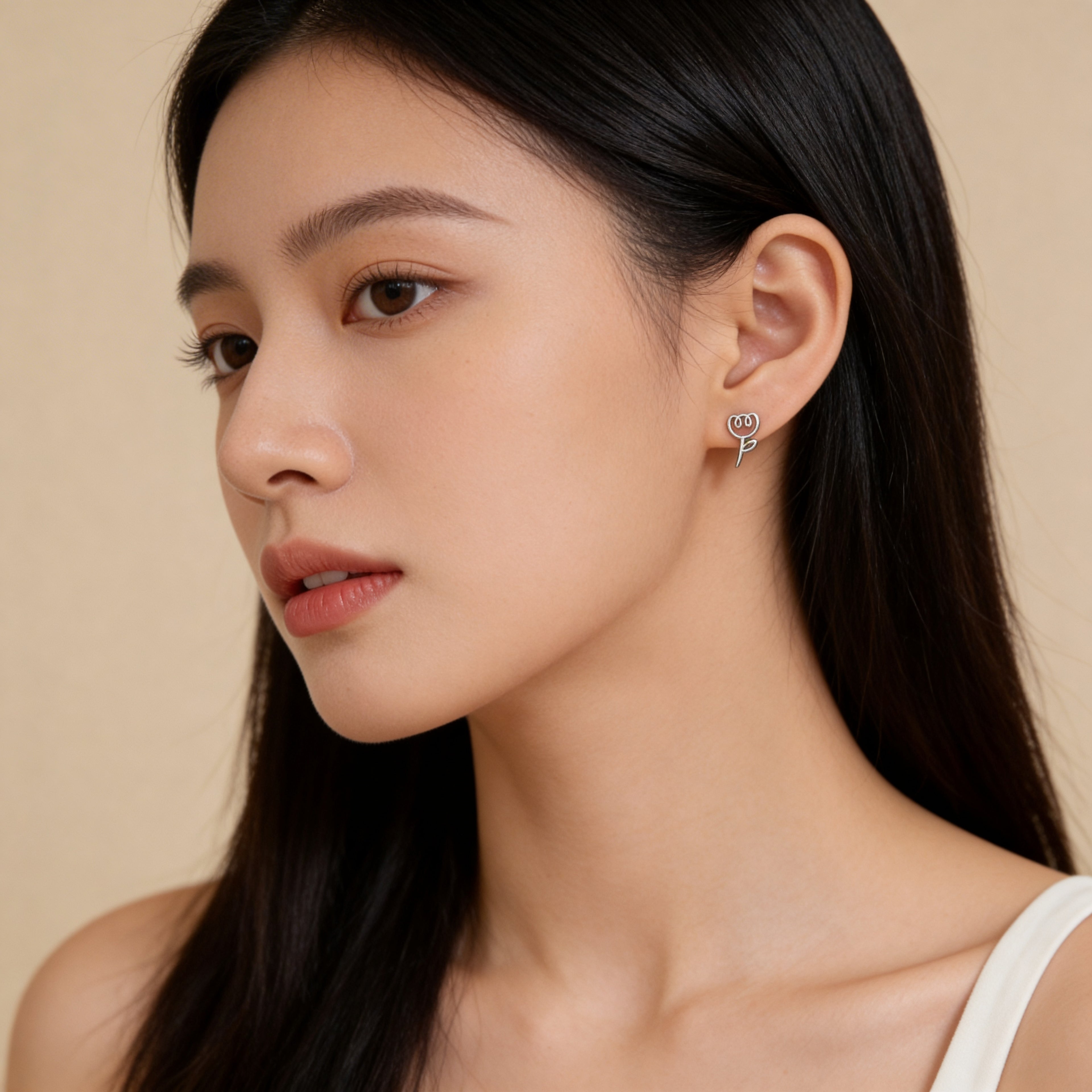 Close up of silver plated tulip stud earrings with butterfly backings.