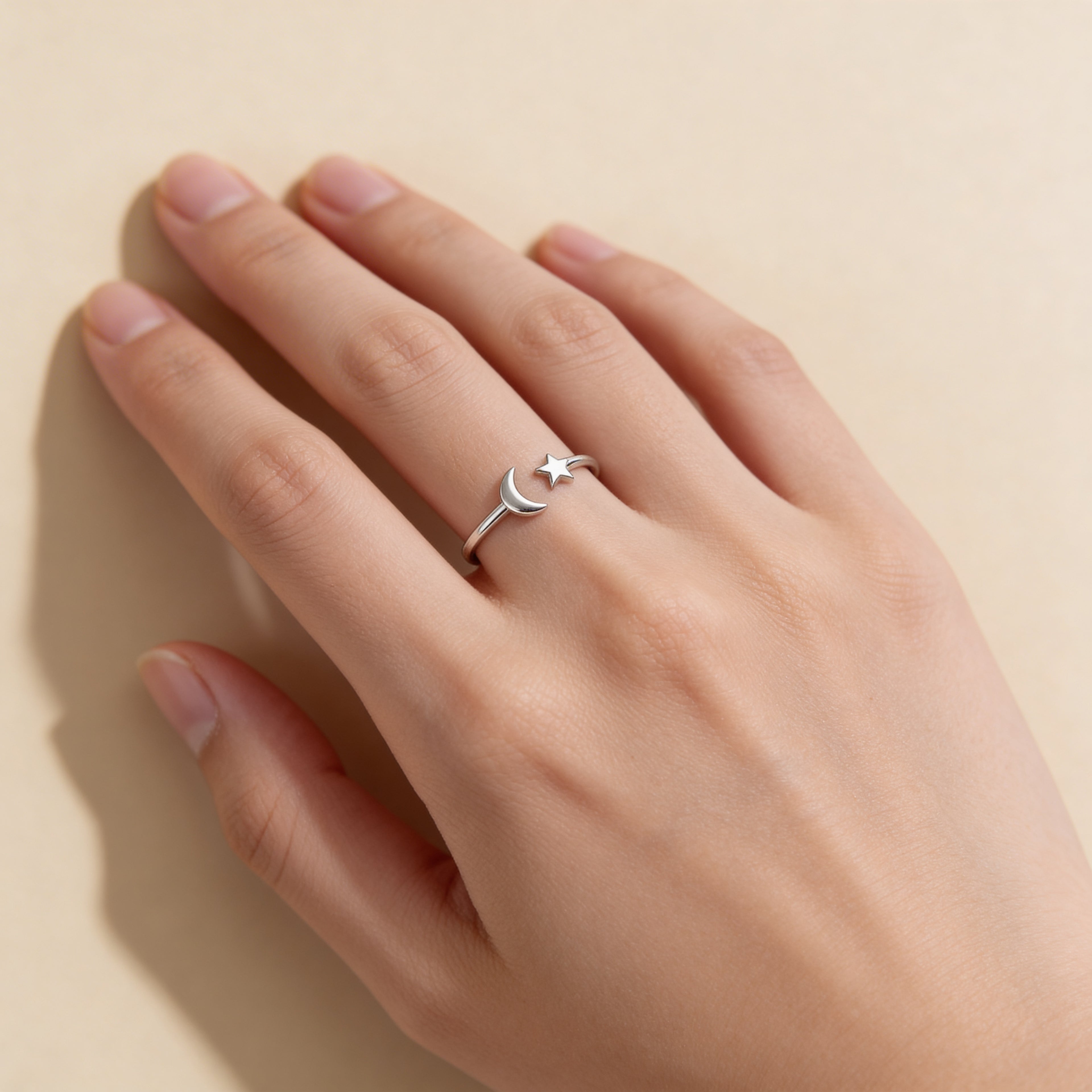 Silver moon and star adjustable ring worn on hand, dainty celestial jewellery