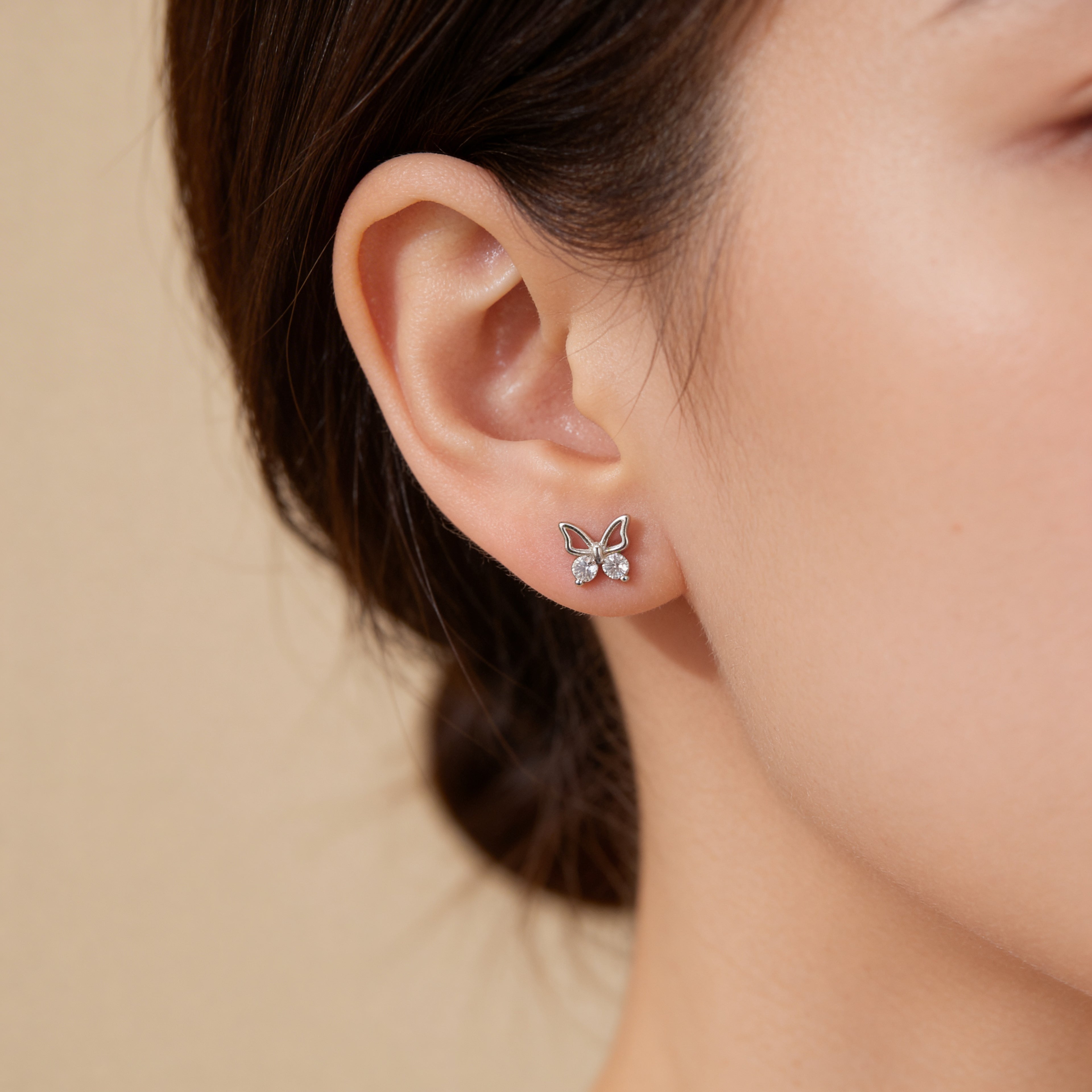 Dainty silver butterfly earrings with cubic zirconia stones.