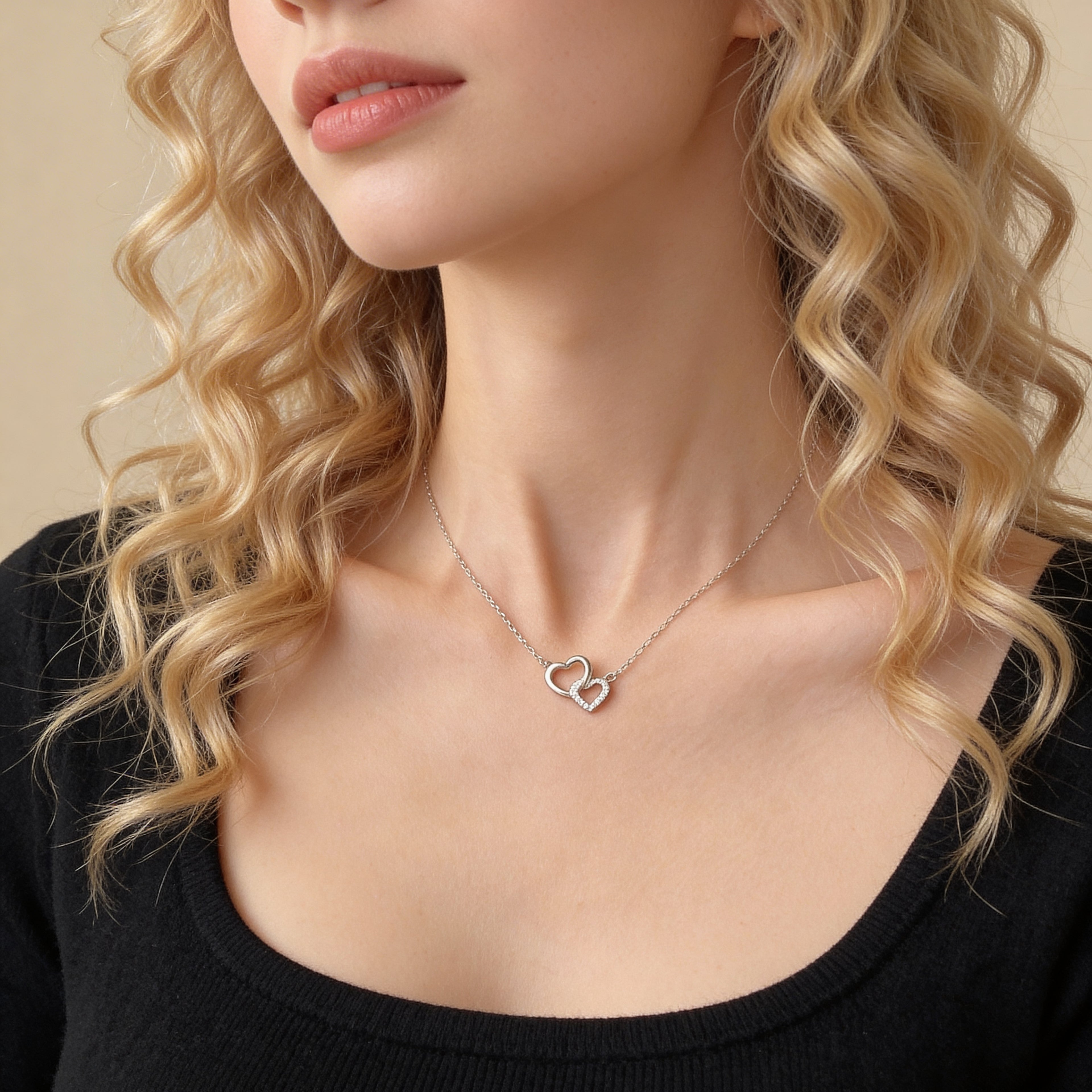 Elegant double heart necklace worn on neck.