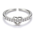 Silver plated adjustable open heart buckle ring with cubic zirconia stones.