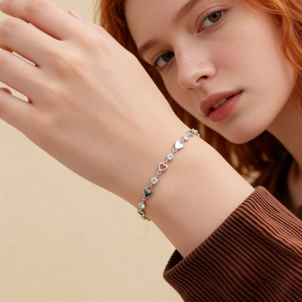 Close up of silver heart bracelet with cubic zirconia crystals.