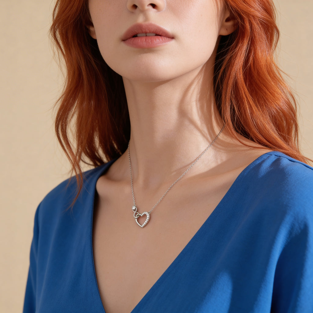 Crystal heart necklace worn by model.