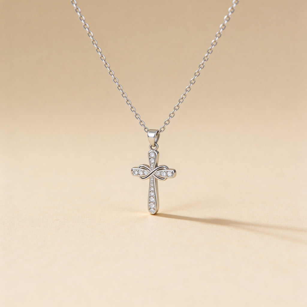 Silver cross pendant necklace on a beige background