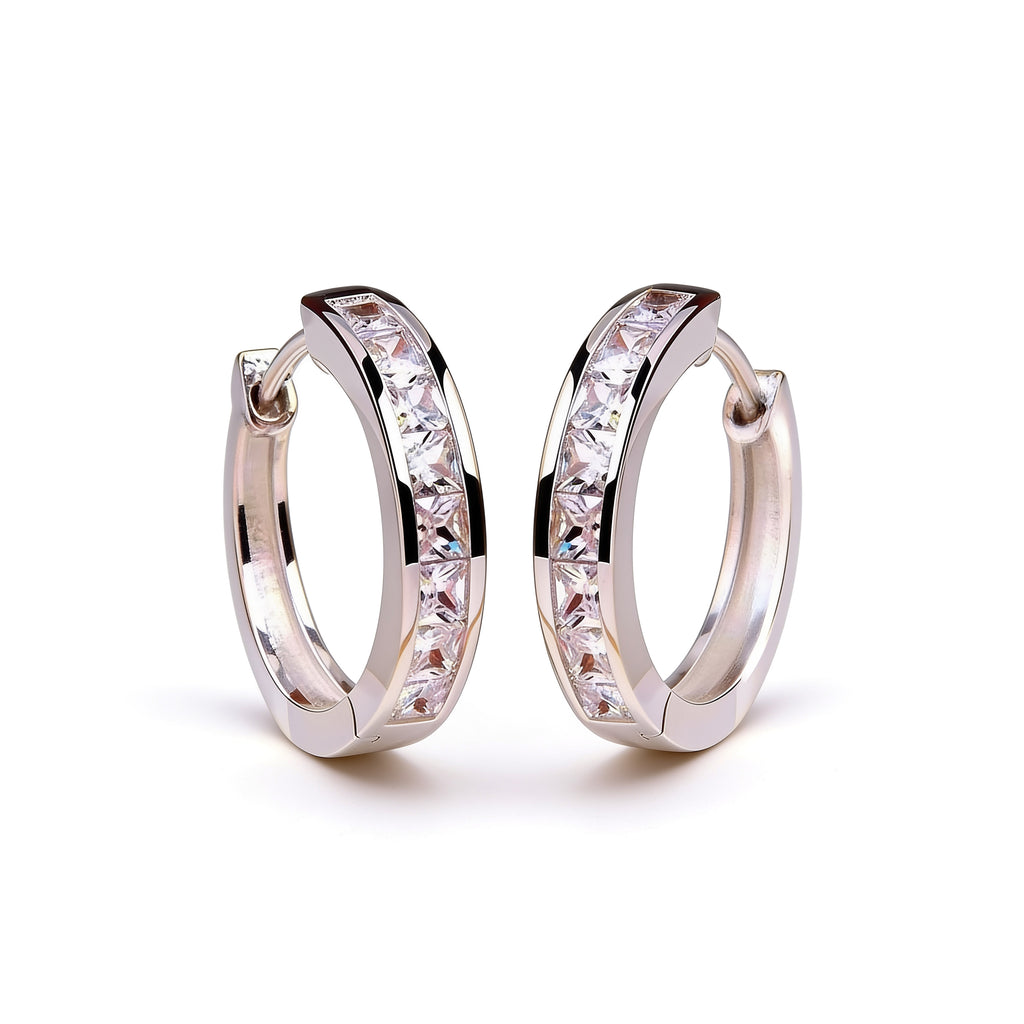Silver plated crystal huggie hoop earrings with sparkling stones shown upright on a clean white background