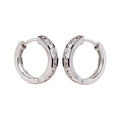 Silver plated crystal huggie hoop earrings with sparkling stones on a clean white background