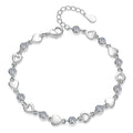 Silver bracelet with heart-shaped links and clear crystals on a white background
