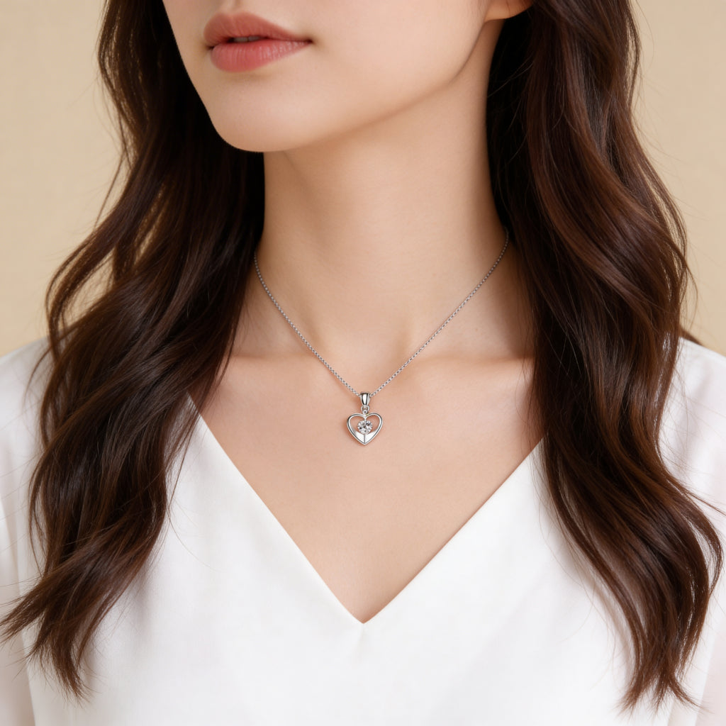 Silver CZ heart necklace worn by model.