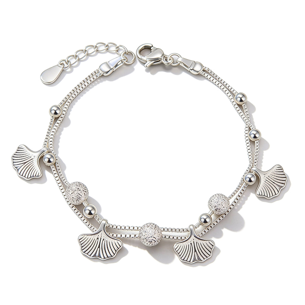 Silver plated leaf charm bracelet with bead accents.