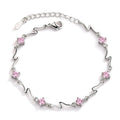 Silver plated pink crystal charm bracelet with light pink stones.
