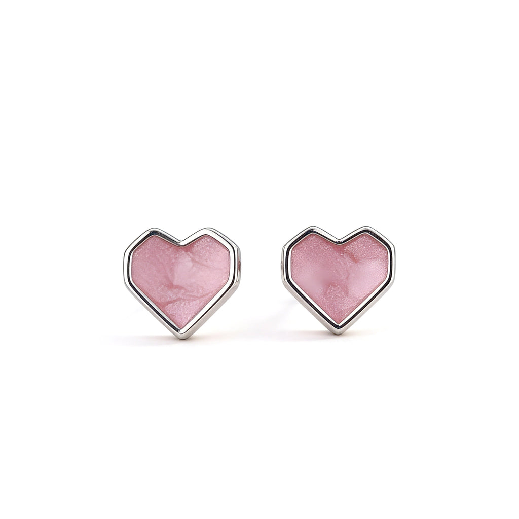Silver plated pink heart stud earrings with glitter finish.