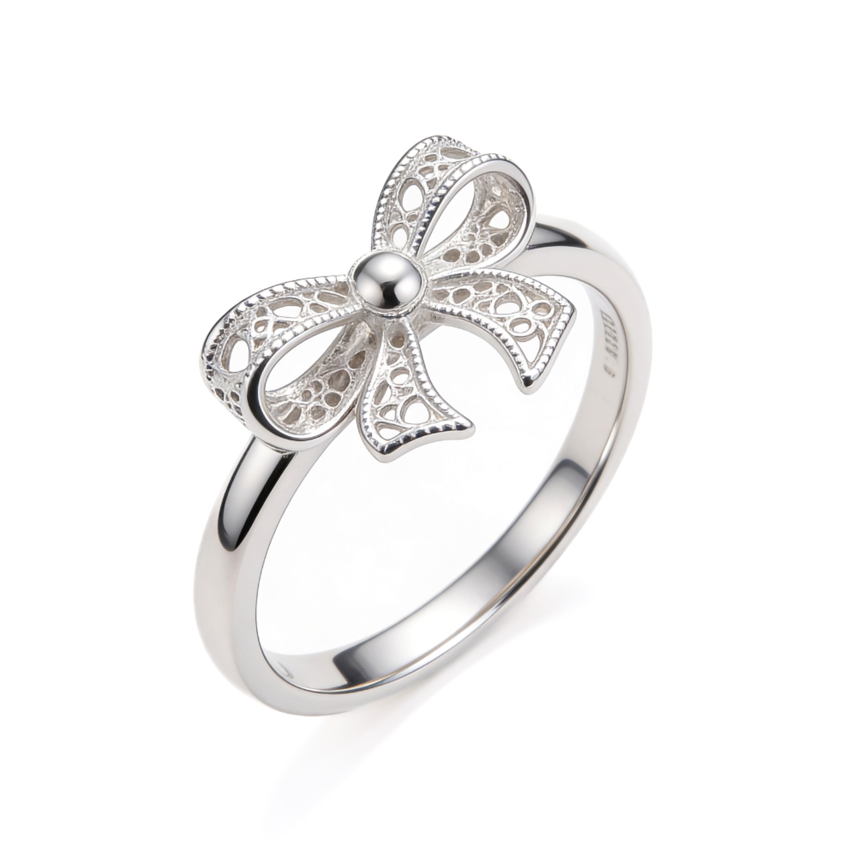 Silver plated adjustable bow ring with intricate filigree detailing.