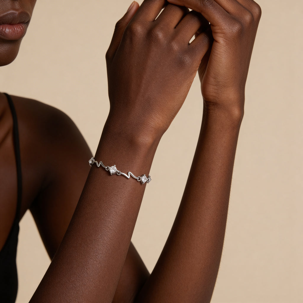 Silver plated bracelet with white crystal charms.