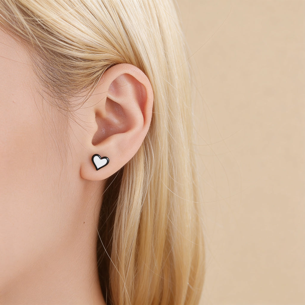 Small dainty black and white heart stud earrings.