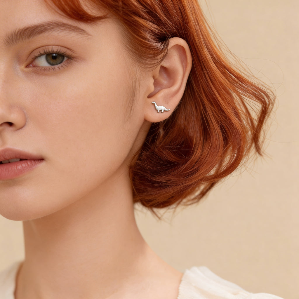 Tiny minimalist silver dino stud earrings.